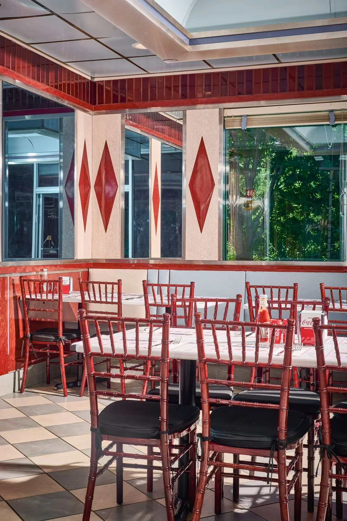 Red booths and diamond windows inside The Diner