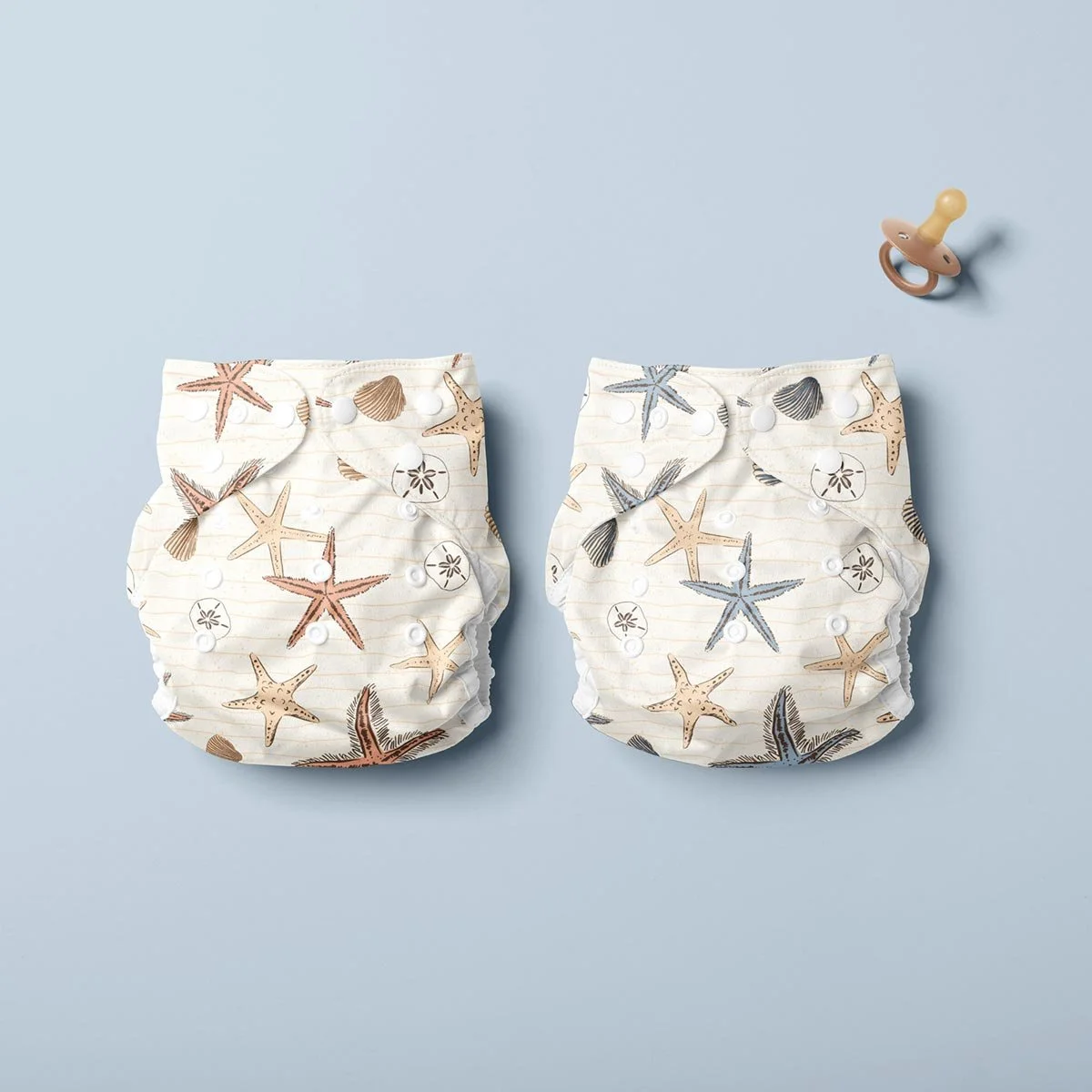 Cute coastal seamless pattern designs featured on a cloth diaper, created for baby accessories, nursery textiles and children’s products.