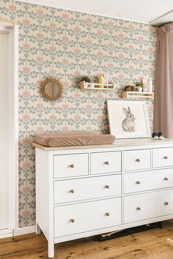 Elegant reading chair and ottoman upholstered in the Brielle botanical floral, styled with a matching lampshade in a light-filled traditional interior.