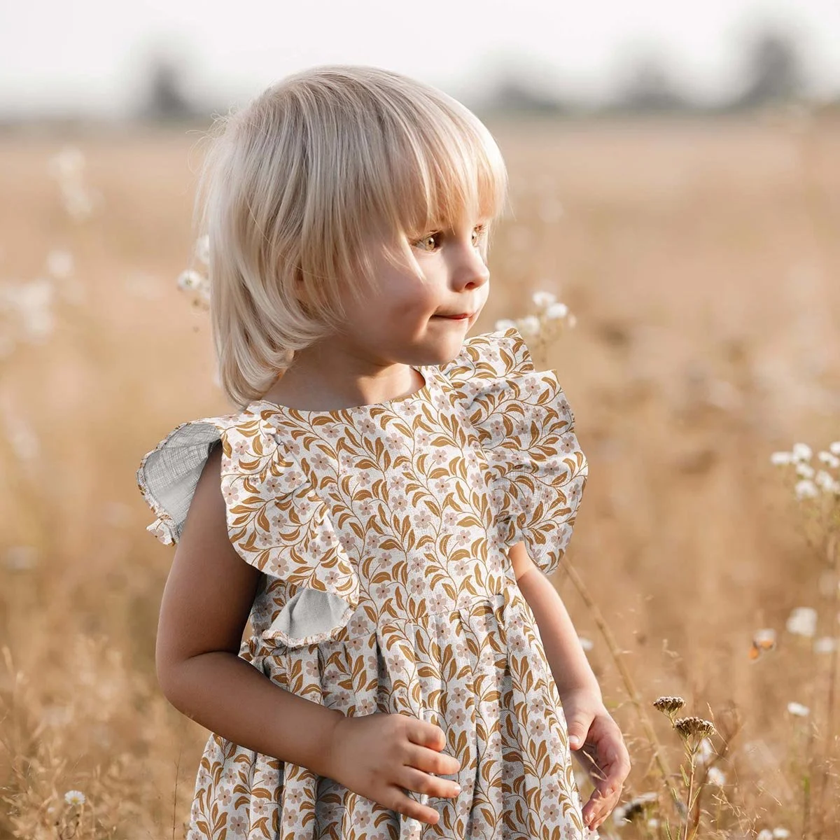 Earthy boho seamless floral pattern design on a cute girl’s dress, featuring warm hand-drawn flowers and a modern folk botanical style.