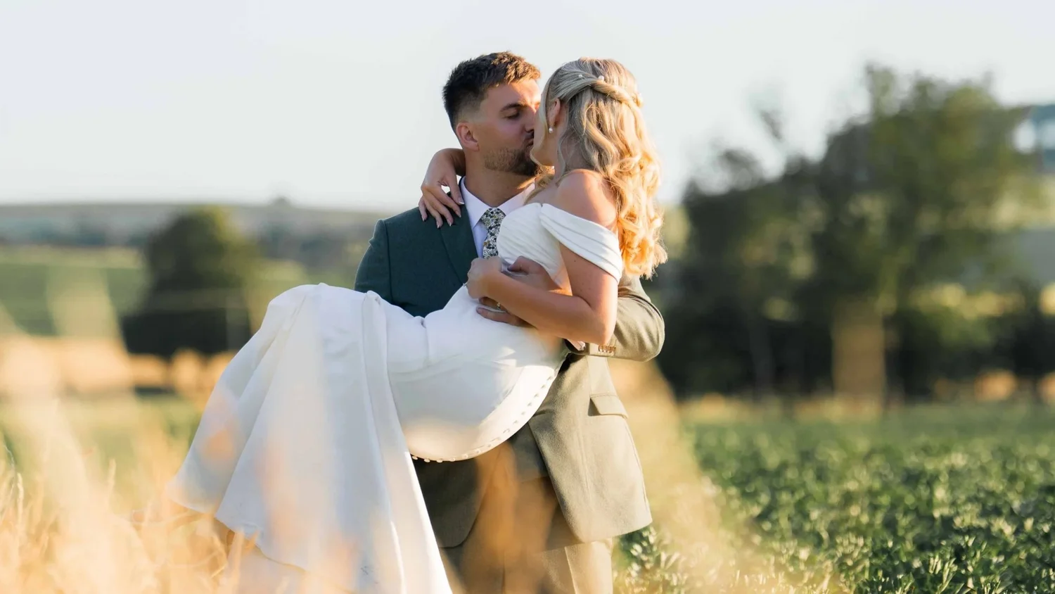 Bride and groom kissing passionately during romantic Berkshire wedding photography at Wasing Park
