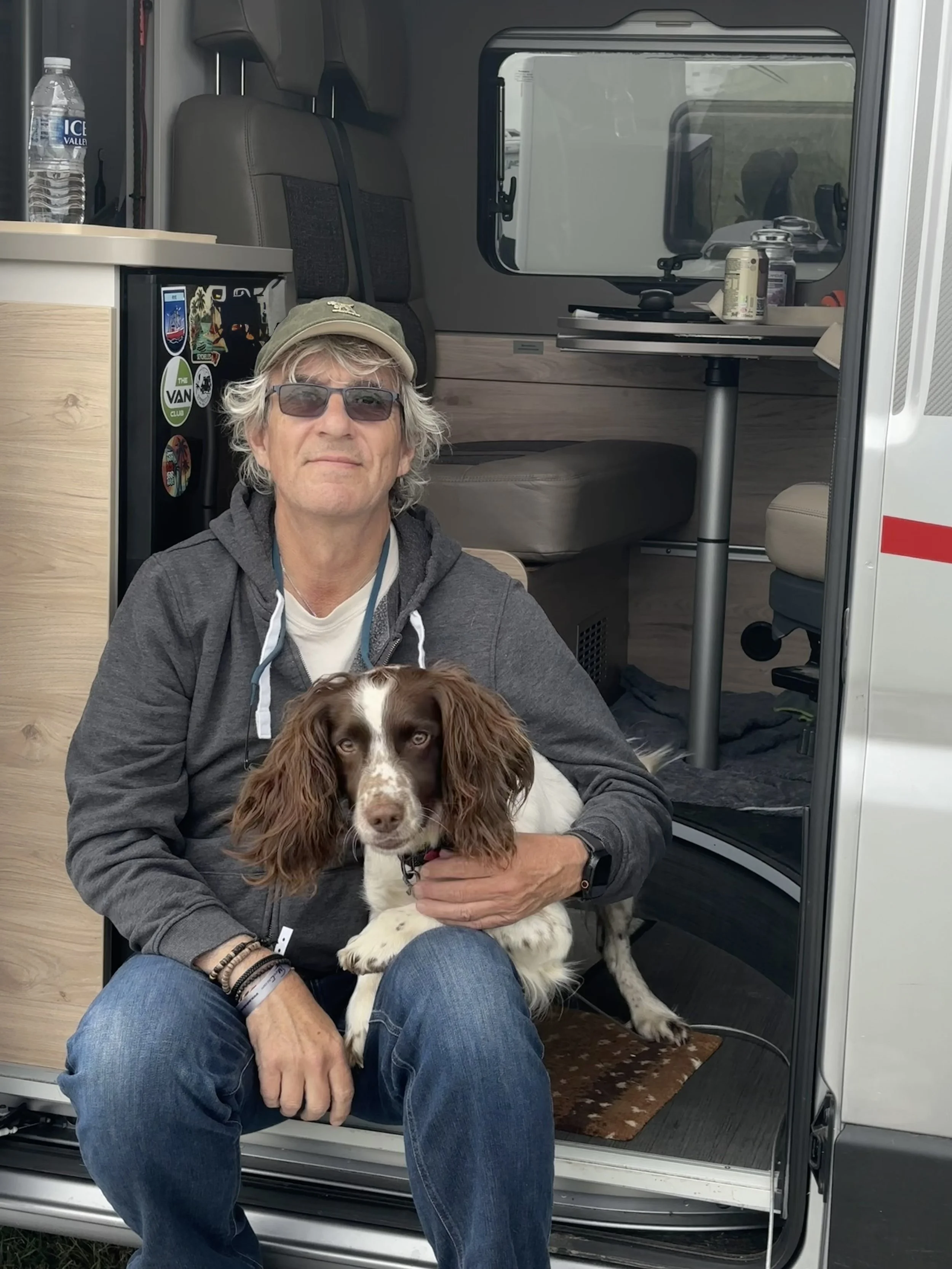 Peter Airs and Jessie the springer spaniel at the door of the van
