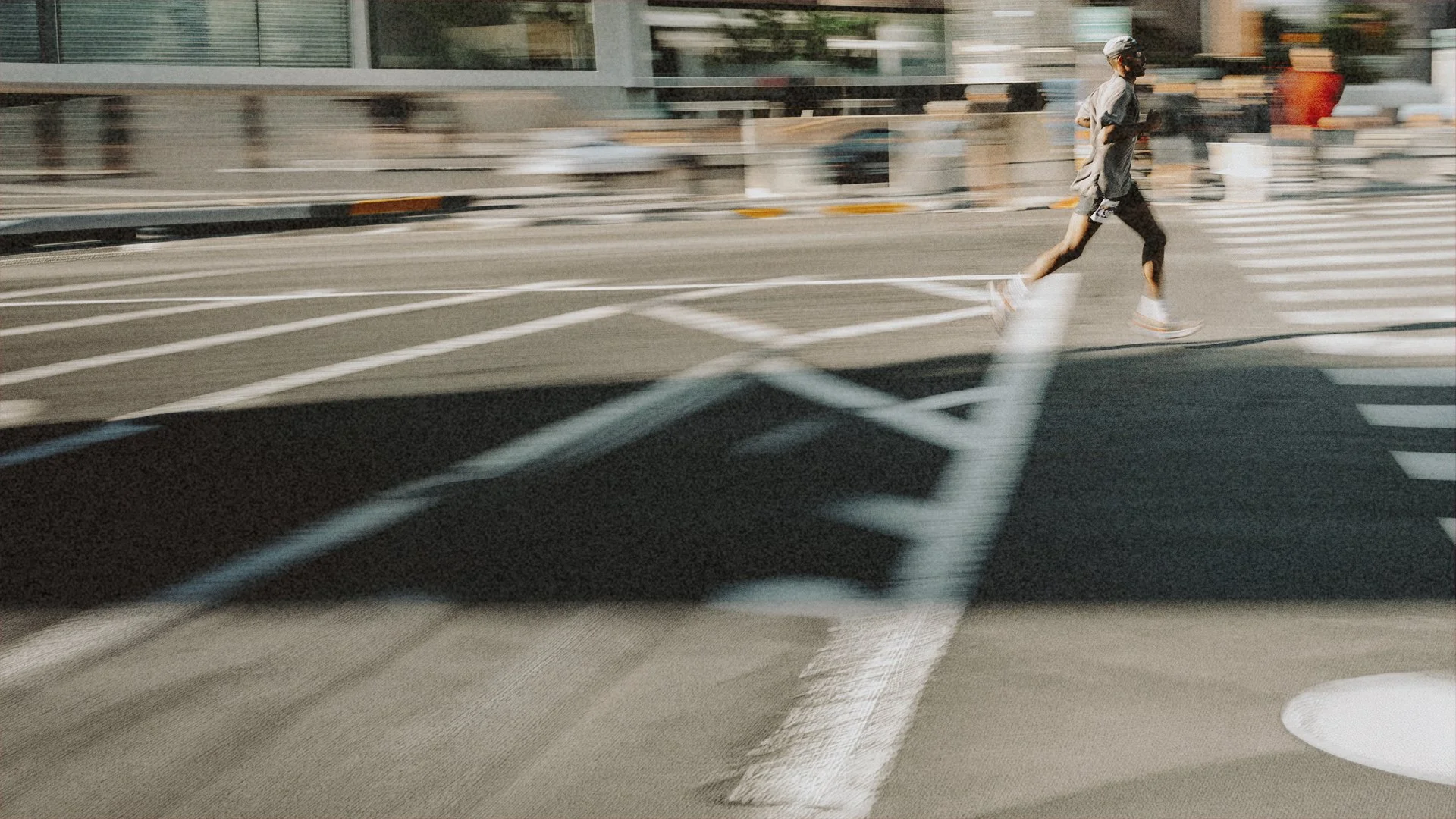 Runner crossing a city street