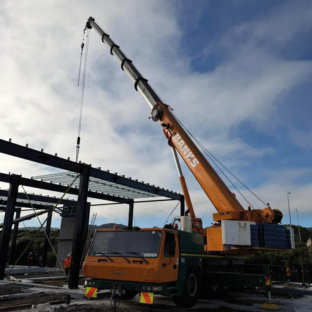 Banks Crane and Transport mobile crane lifting structural steel during a commercial construction project.