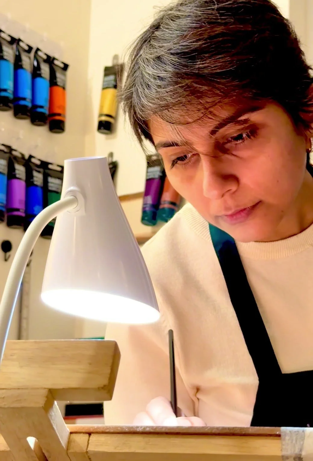 Neha Tandon painting at her easel in the N'marks studio, Bengaluru