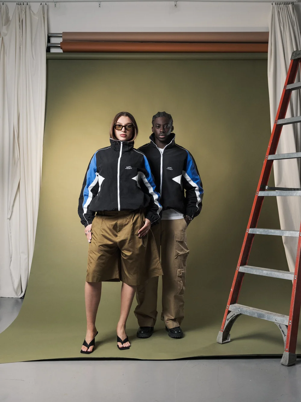 Two models wearing Vanity Apparel jackets in a studio campaign