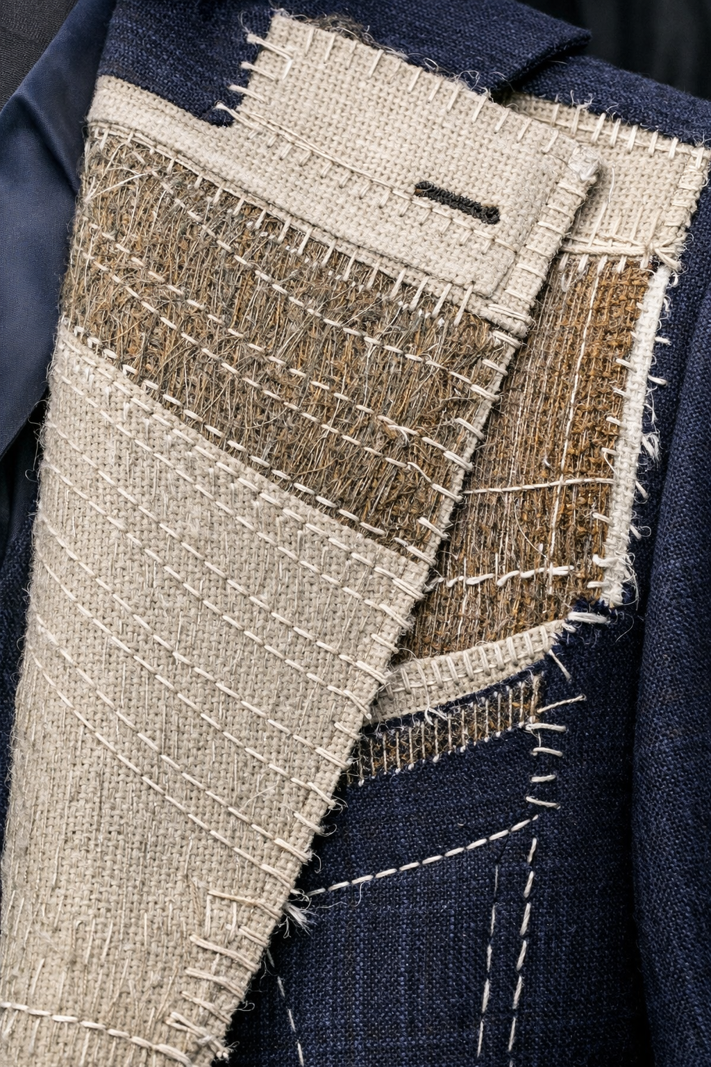 Full canvas suit construction showing horsehair interlining hand-stitched throughout the jacket for a body-moulding fit