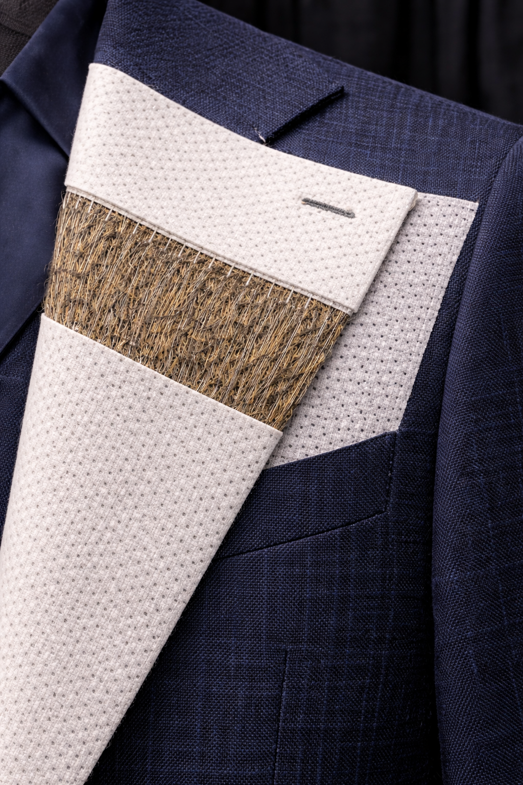 Fused suit construction with glued interlining for a budget-friendly but stiffer fit