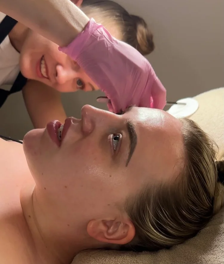Ceejay smiling during a dermaplaning facial