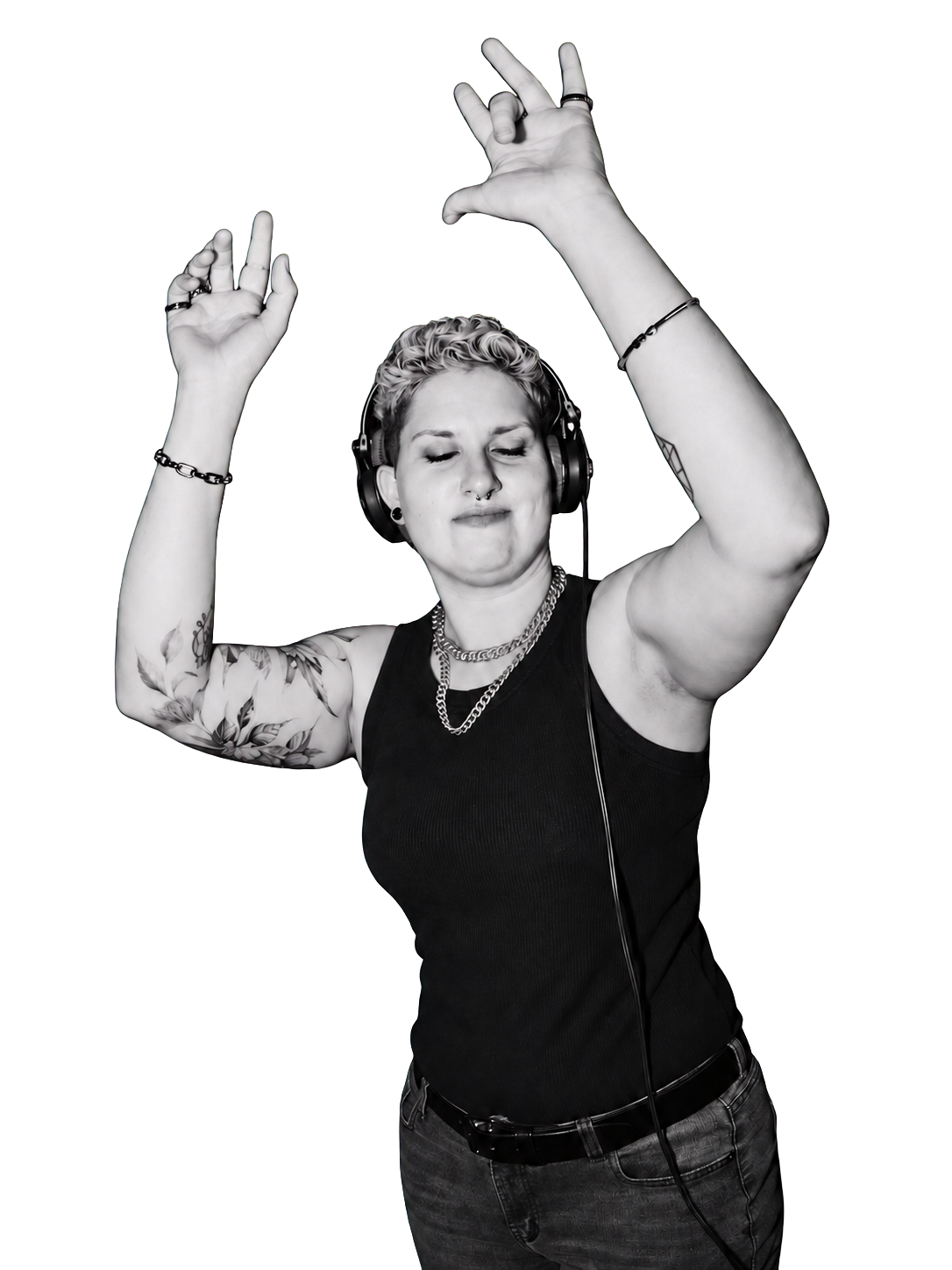 DJ GK wearing headphones with both arms raised