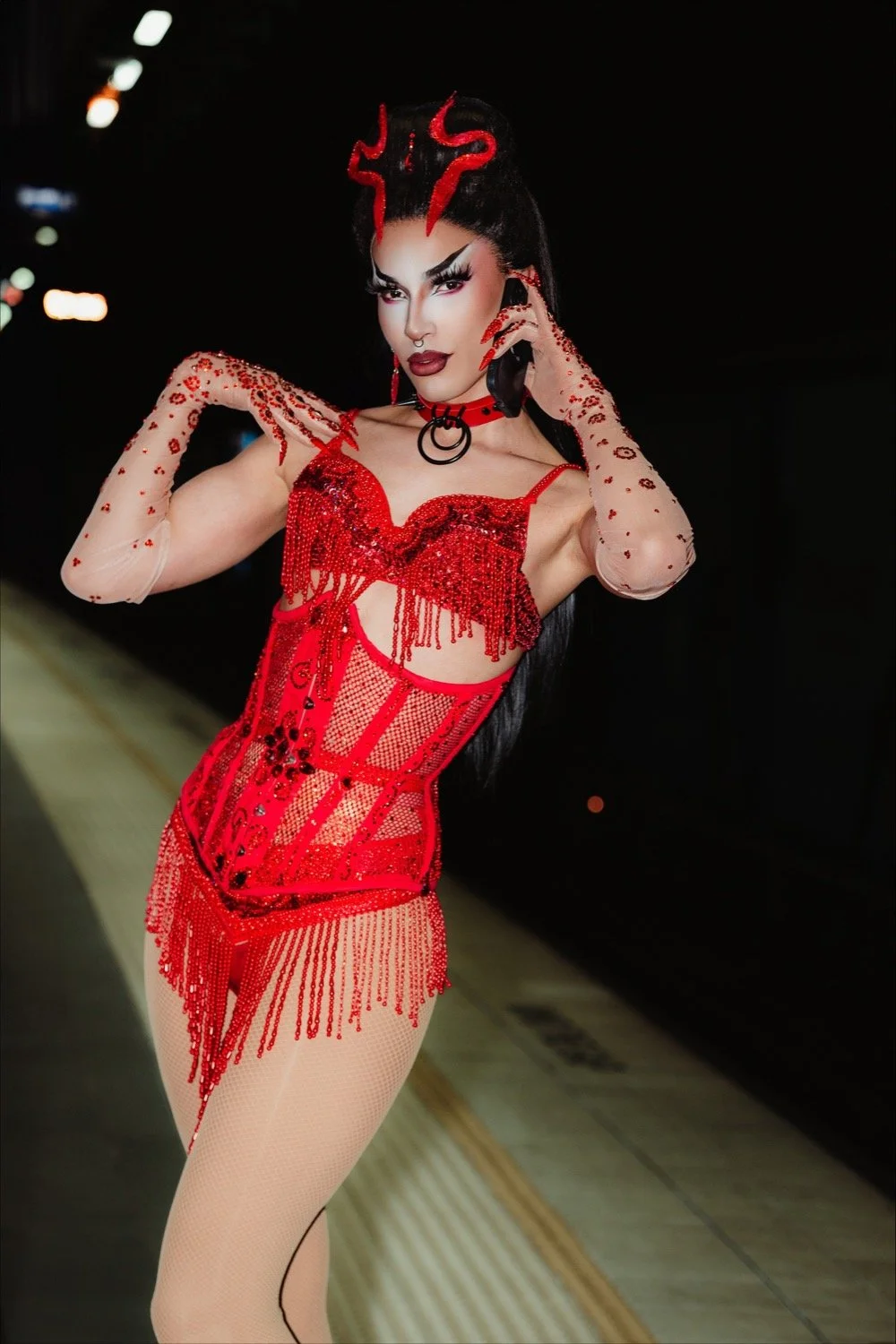 Gothic Marika with a black updo, red hair ornaments and a red beaded costume