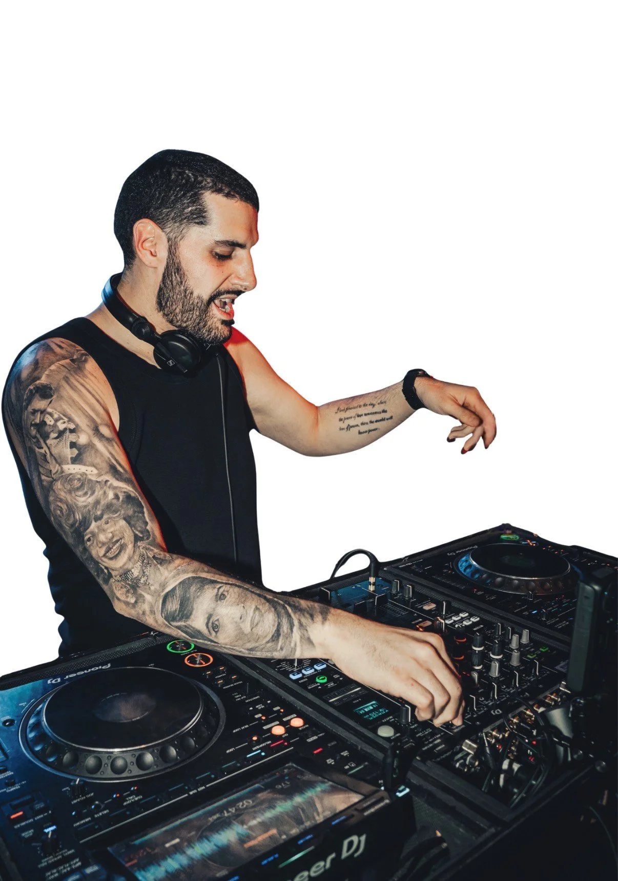 DJ Gaydrian wearing headphones and a black sleeveless shirt while performing at the decks