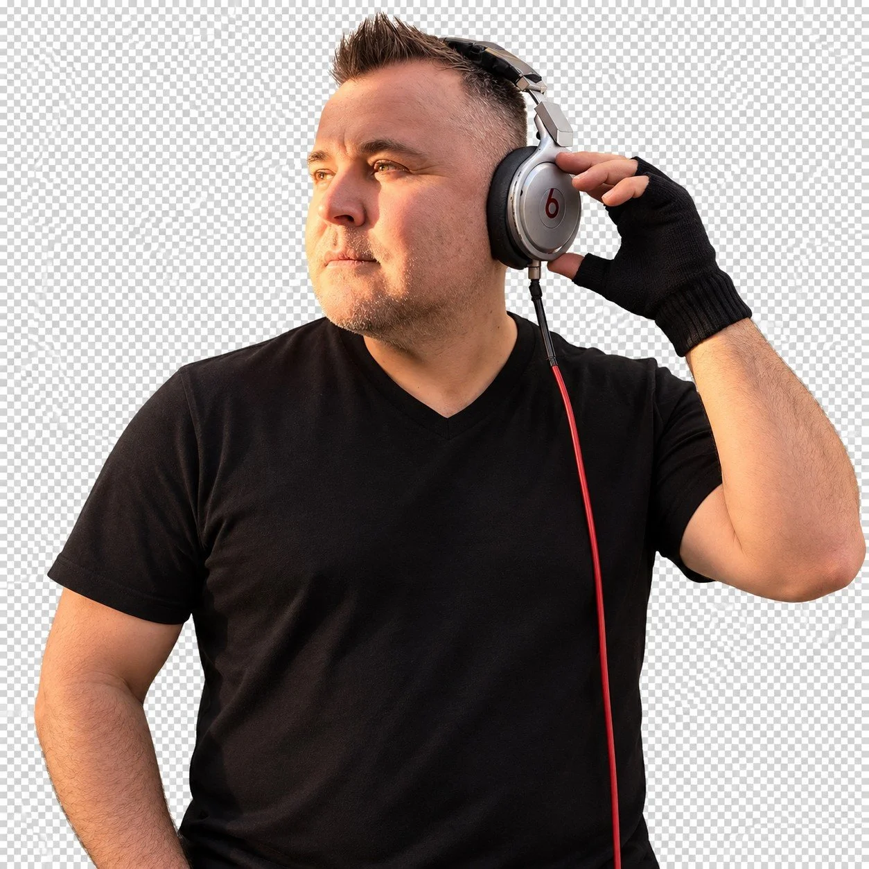 DJ Shanie D in a black shirt holding his silver headphones
