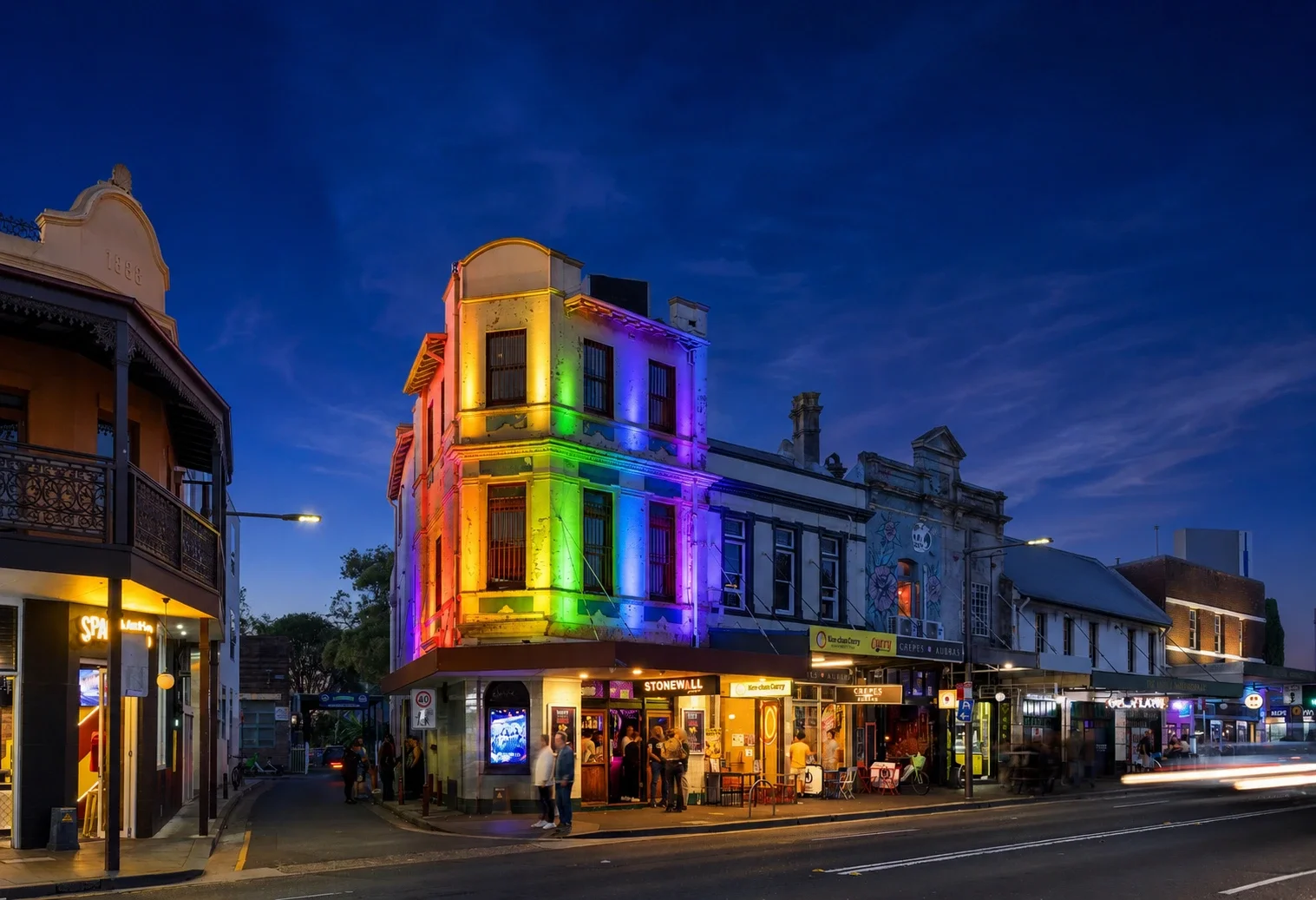 Stonewall Newtown’s facade illuminated in rainbow colours at night