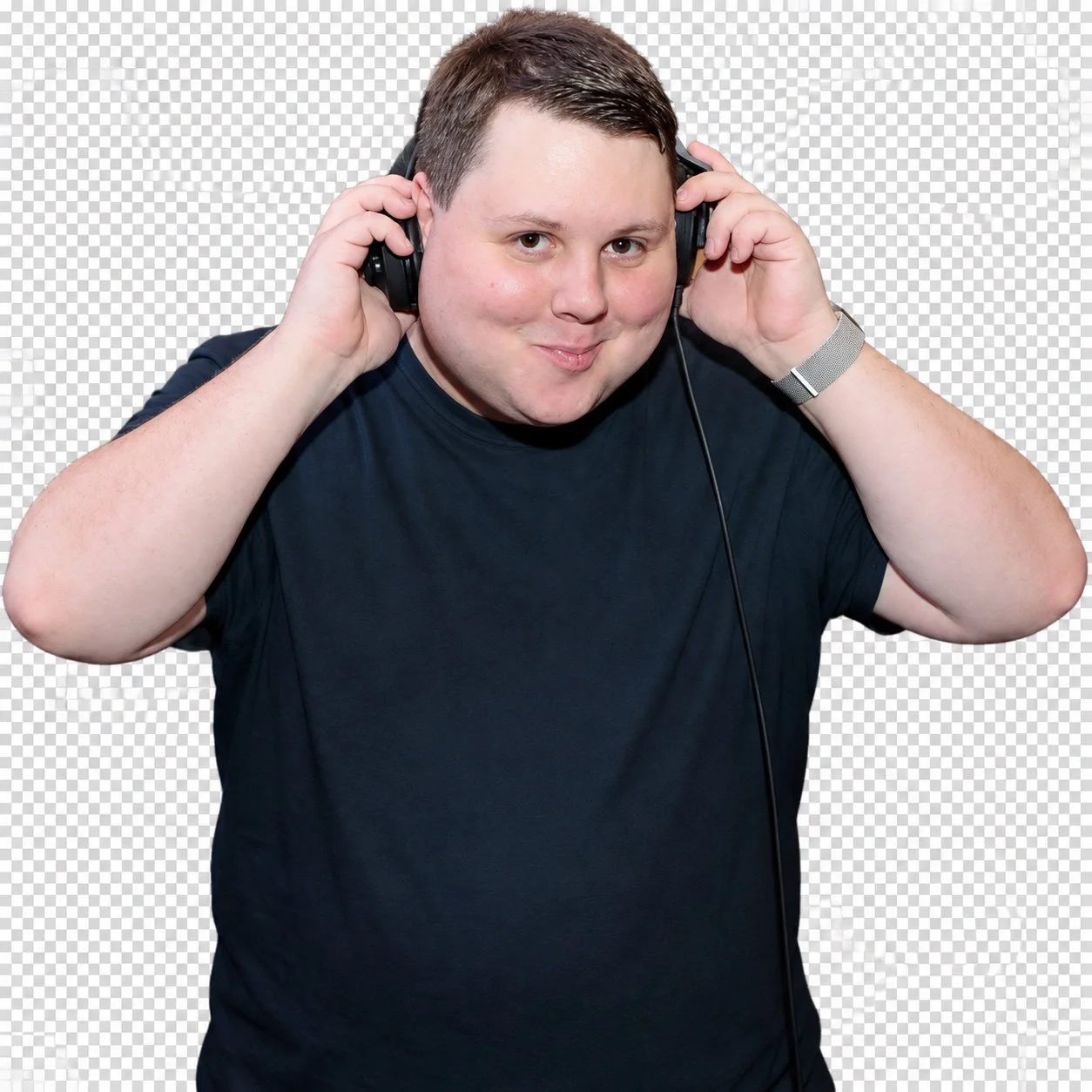 Tom Rogers holding his headphones at the DJ booth