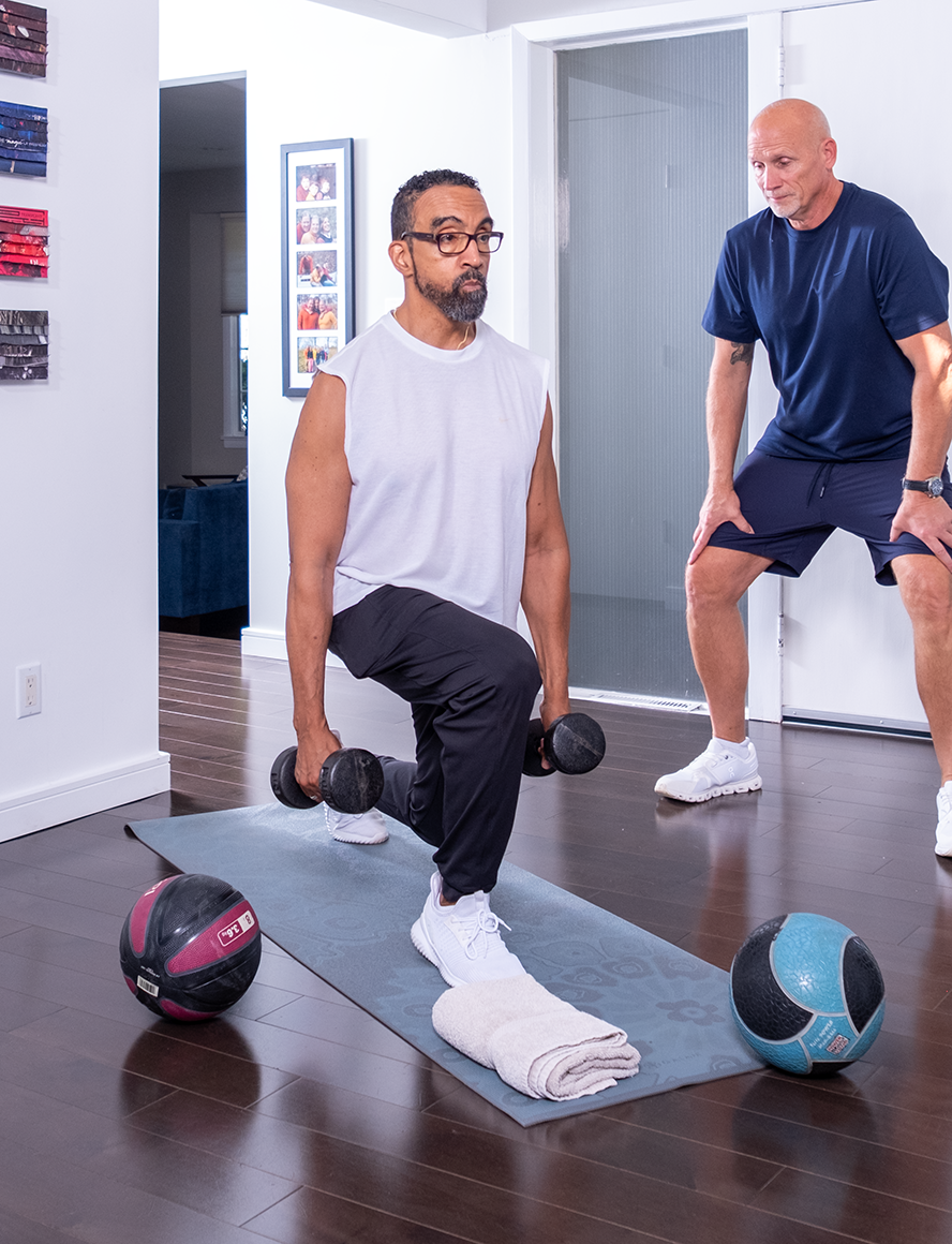 Personal trainer guiding a strength training exercise