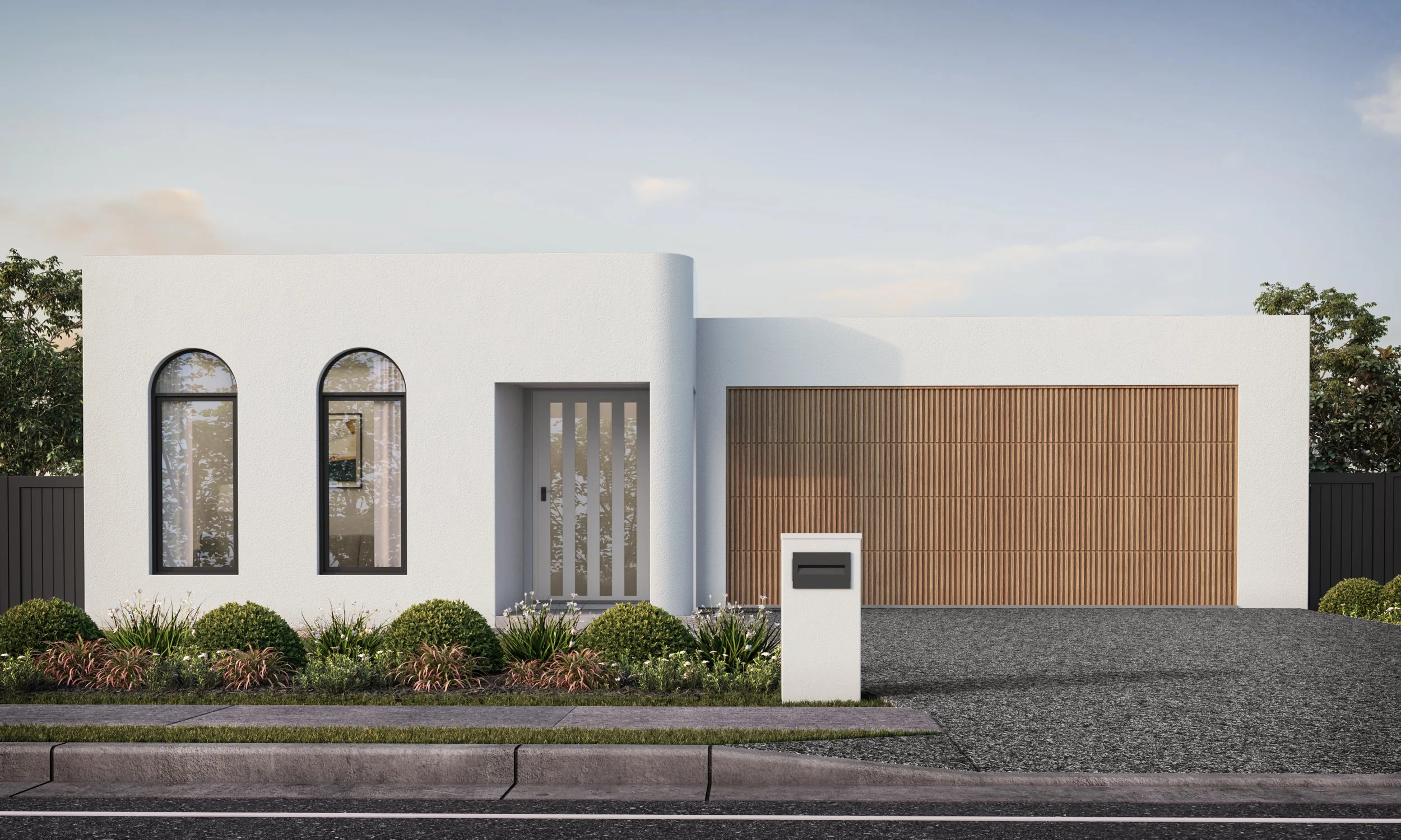 White rendered home with arched windows and a timber garage door