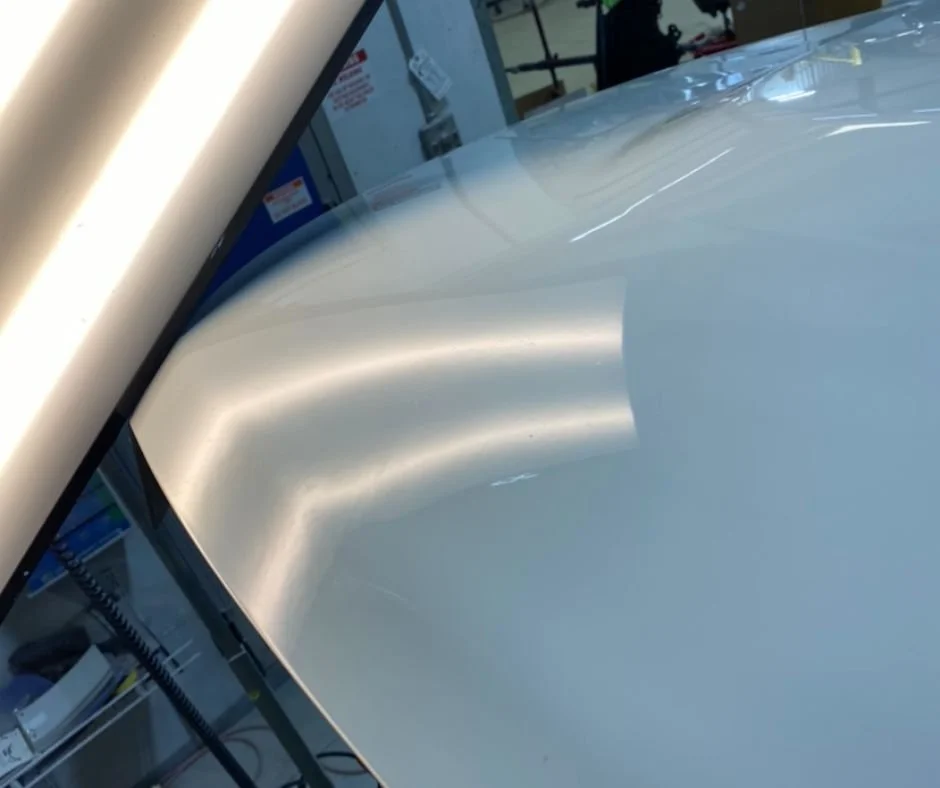 Paintless dent repair on hood — after