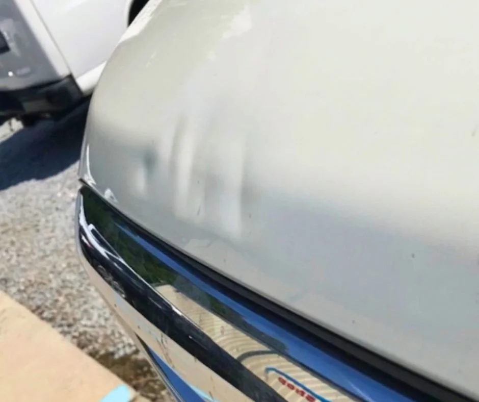 Paintless dent repair on hood — before