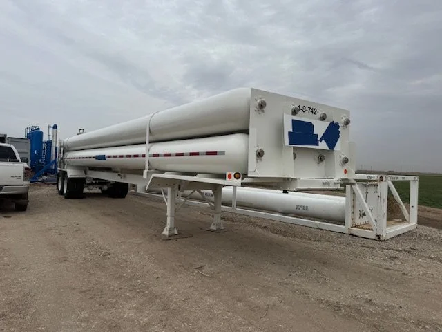 White tube trailer parked at the wellsite