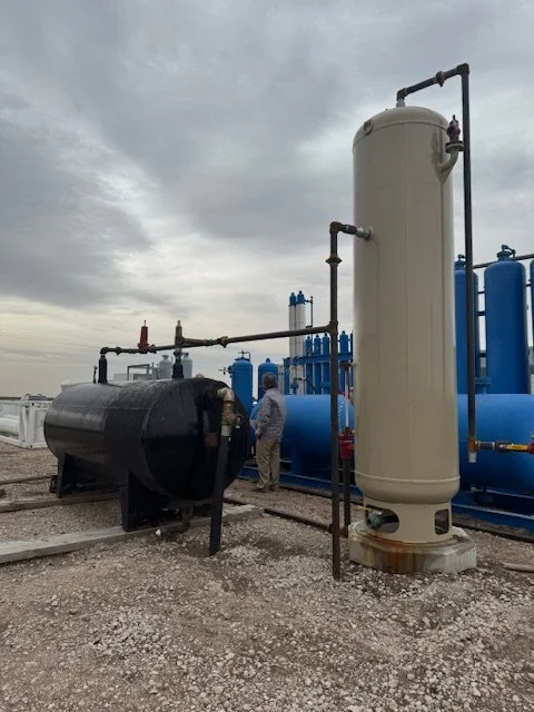 Vertical vessel beside a black horizontal tank
