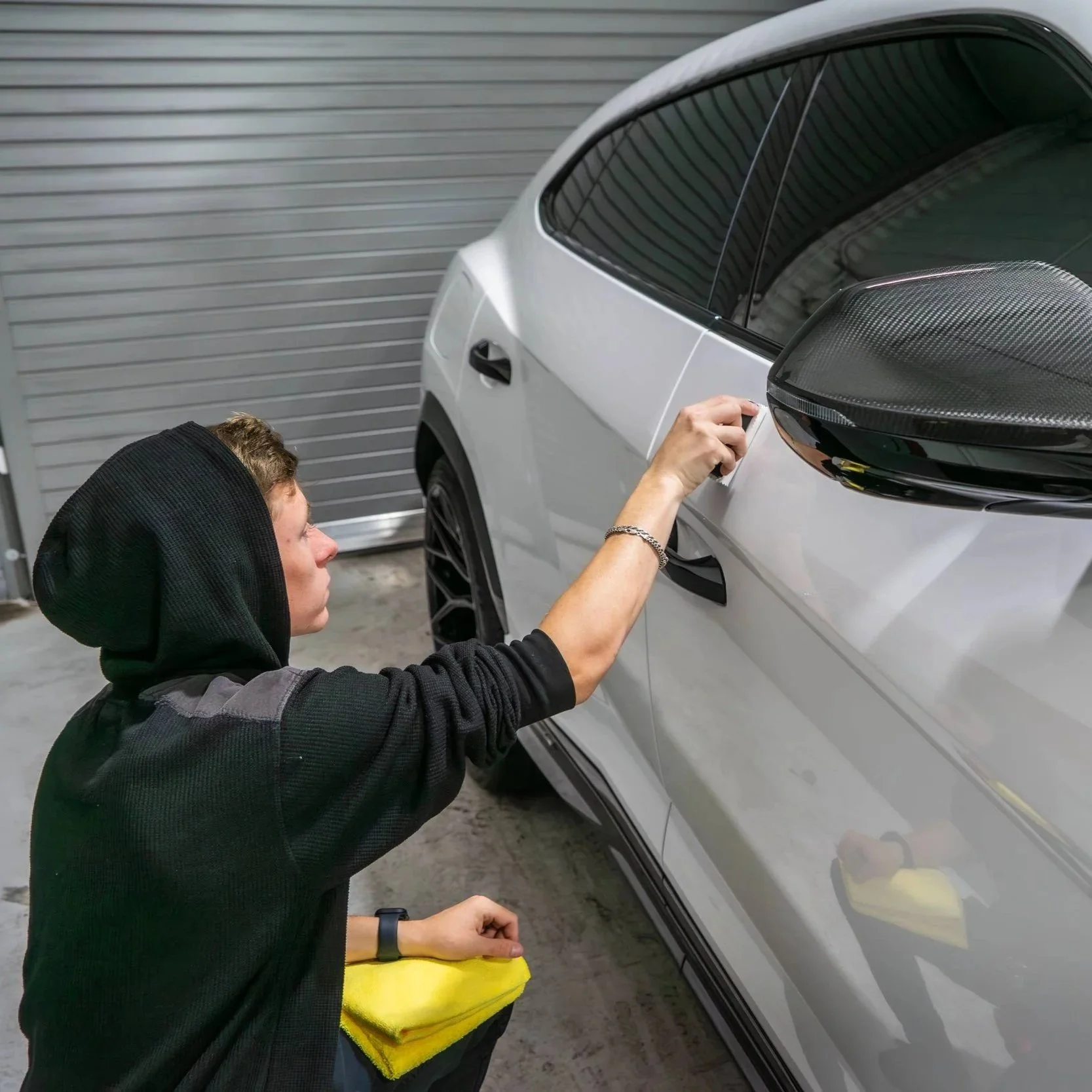 sunlit glossy car hood with faint swirl marks
