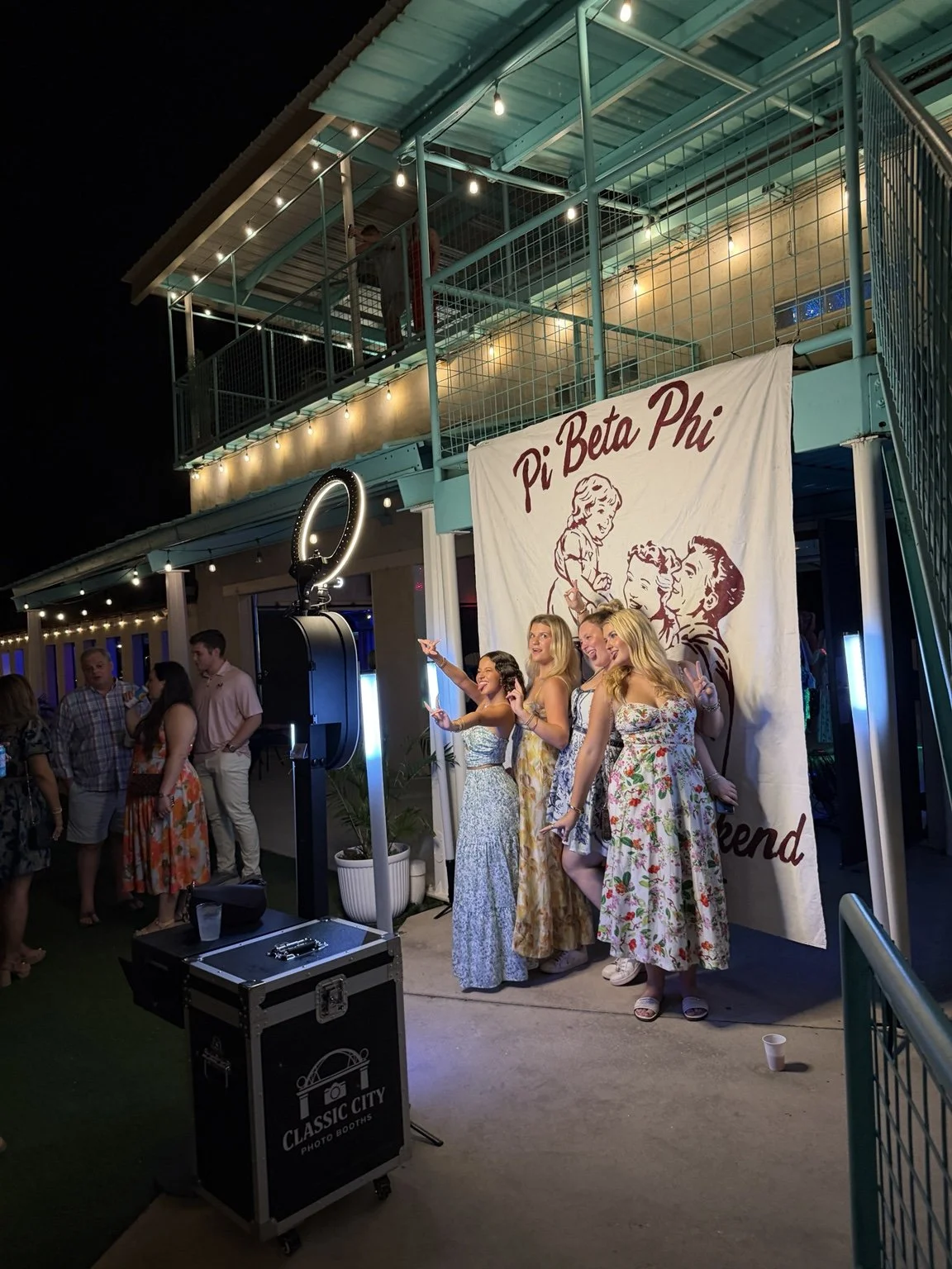 Guests posing beside the Classic City photo booth at Pi Beta Phi Parents Weekend, Fall 2026