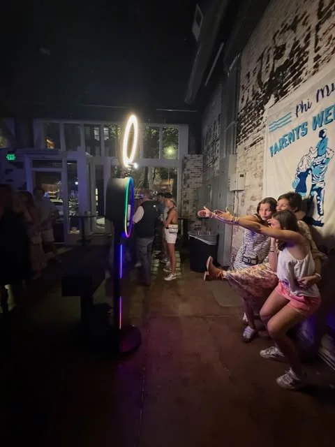 Guests using a lighted Classic City Photo Booths setup at an Athens venue
