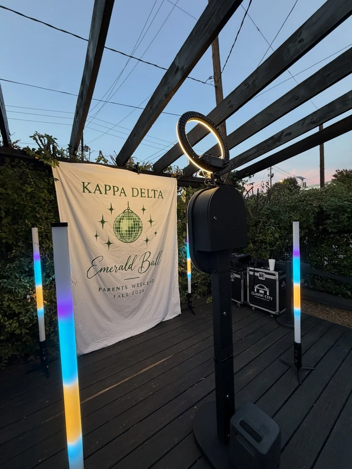 Classic City open-air booth and illuminated towers beside the Kappa Delta Emerald Ball backdrop