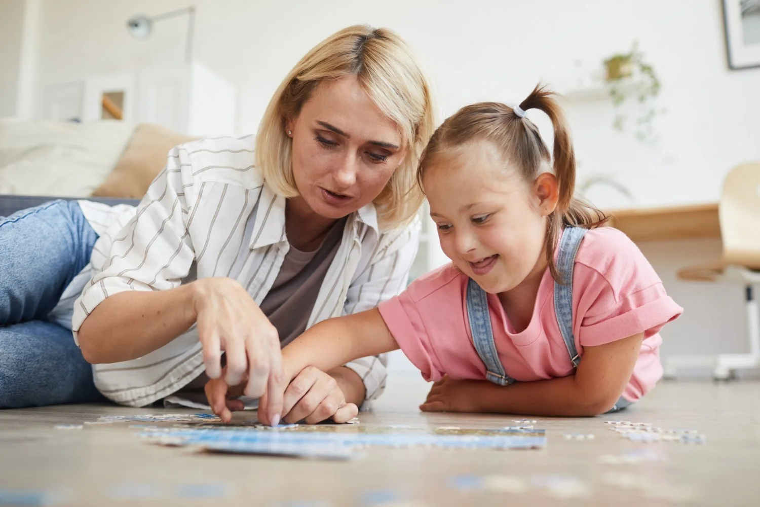 An adult and a child reading a picture book together
