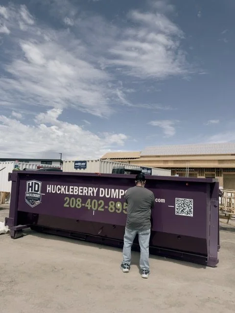 Huckleberry Dumpsters 20-yard purple dumpster at a construction jobsite