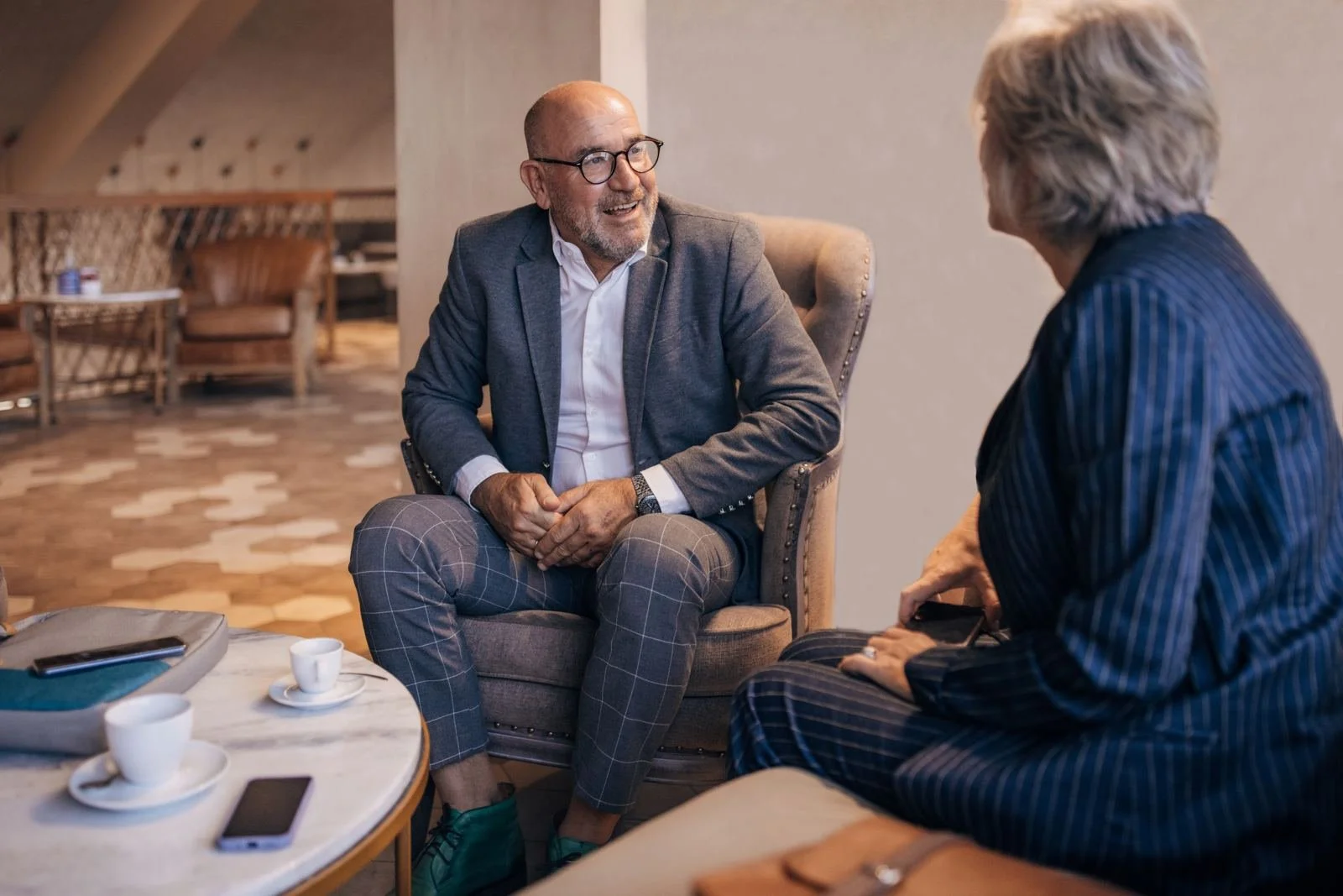 Two people in conversation in a hotel lobby