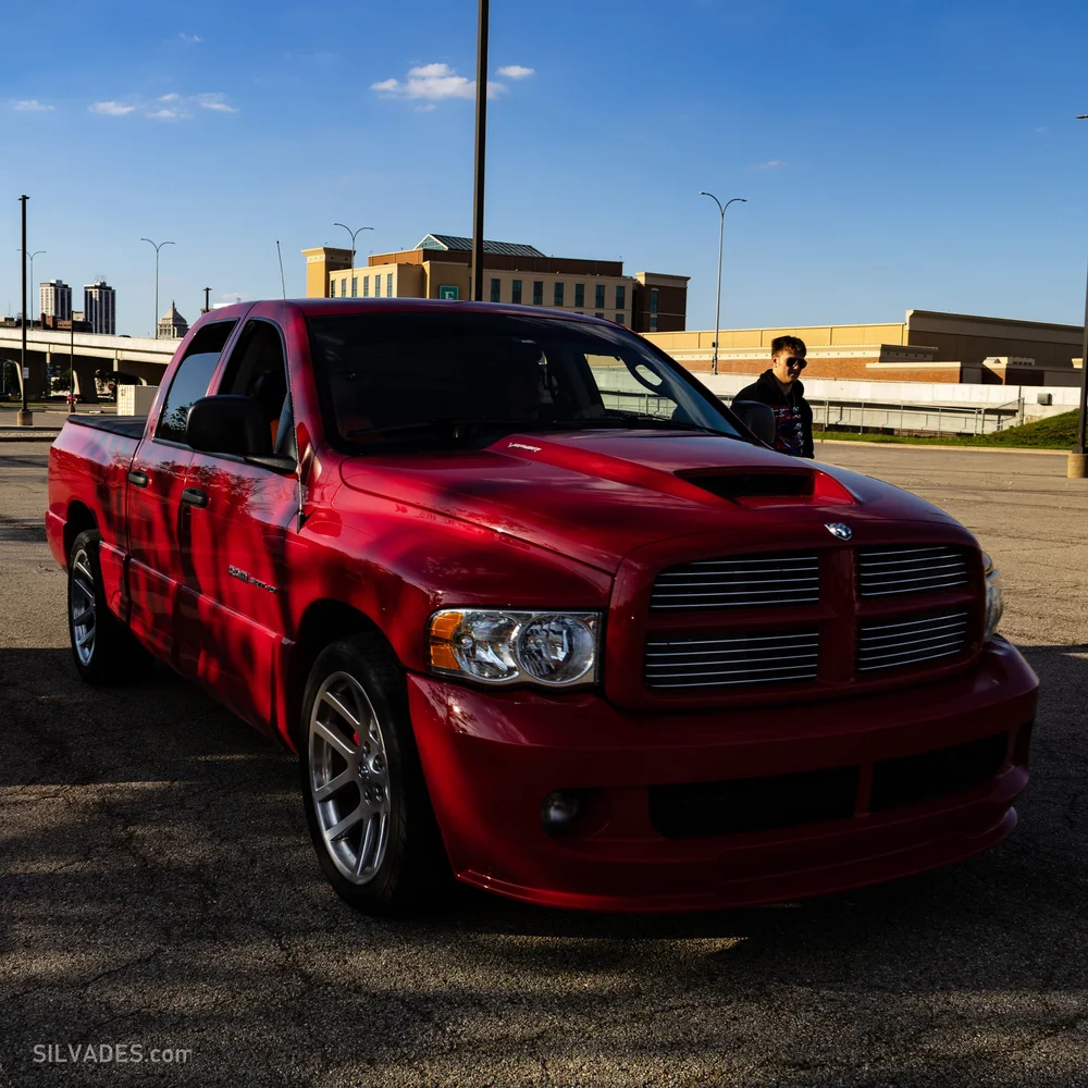 Red Dodge Ram SRT-10 sport truck photographed at golden hour