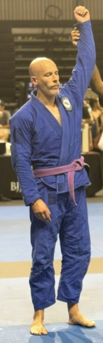 Jonathan Borella in a blue gi at a Brazilian Jiu-Jitsu competition
