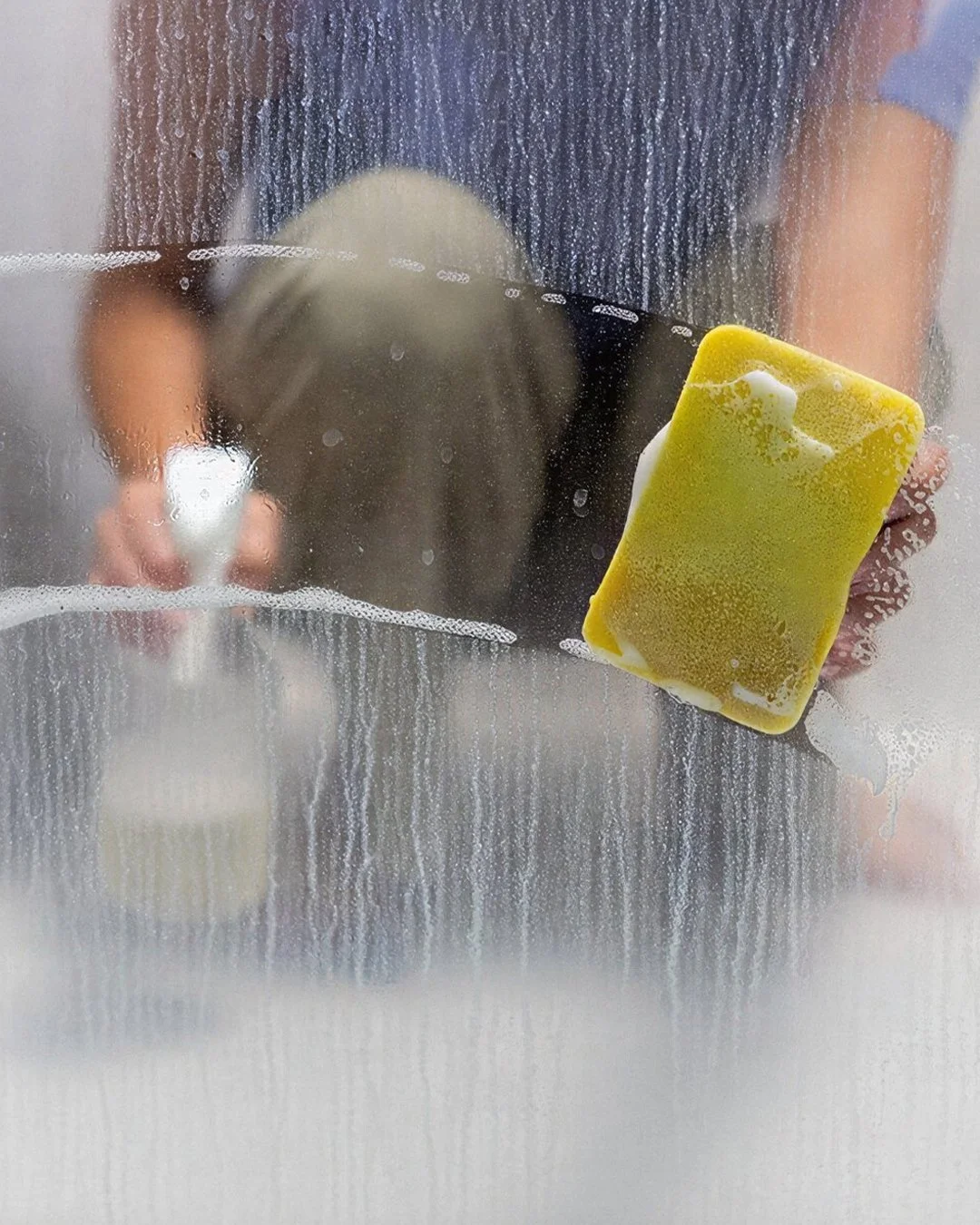 Squeegee Cleaning Soap off Glass
