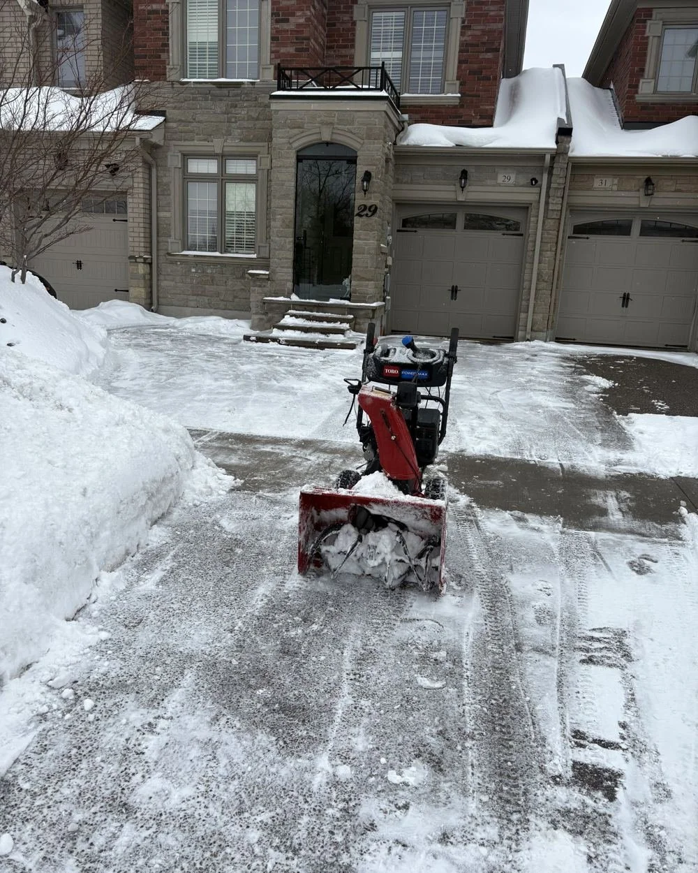QuickPlowz snowblower clearing a snowy driveway