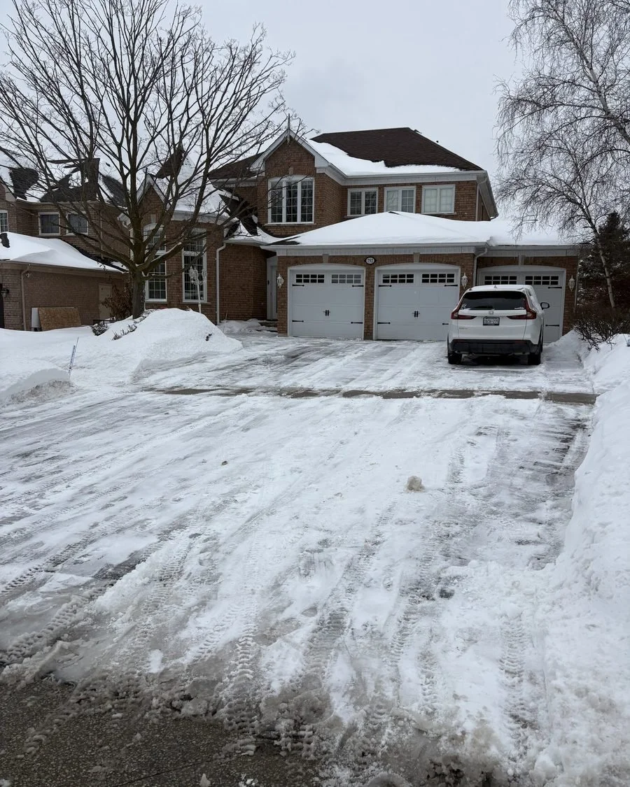 Wide three-car driveway cleared after a storm