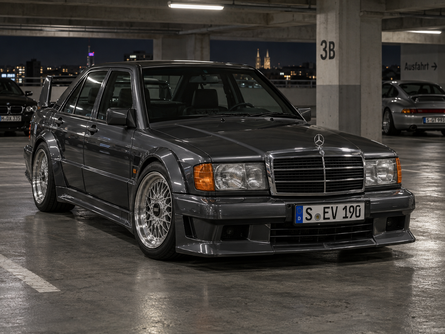 Gunmetal Mercedes 190E Evo style car in a parking garage