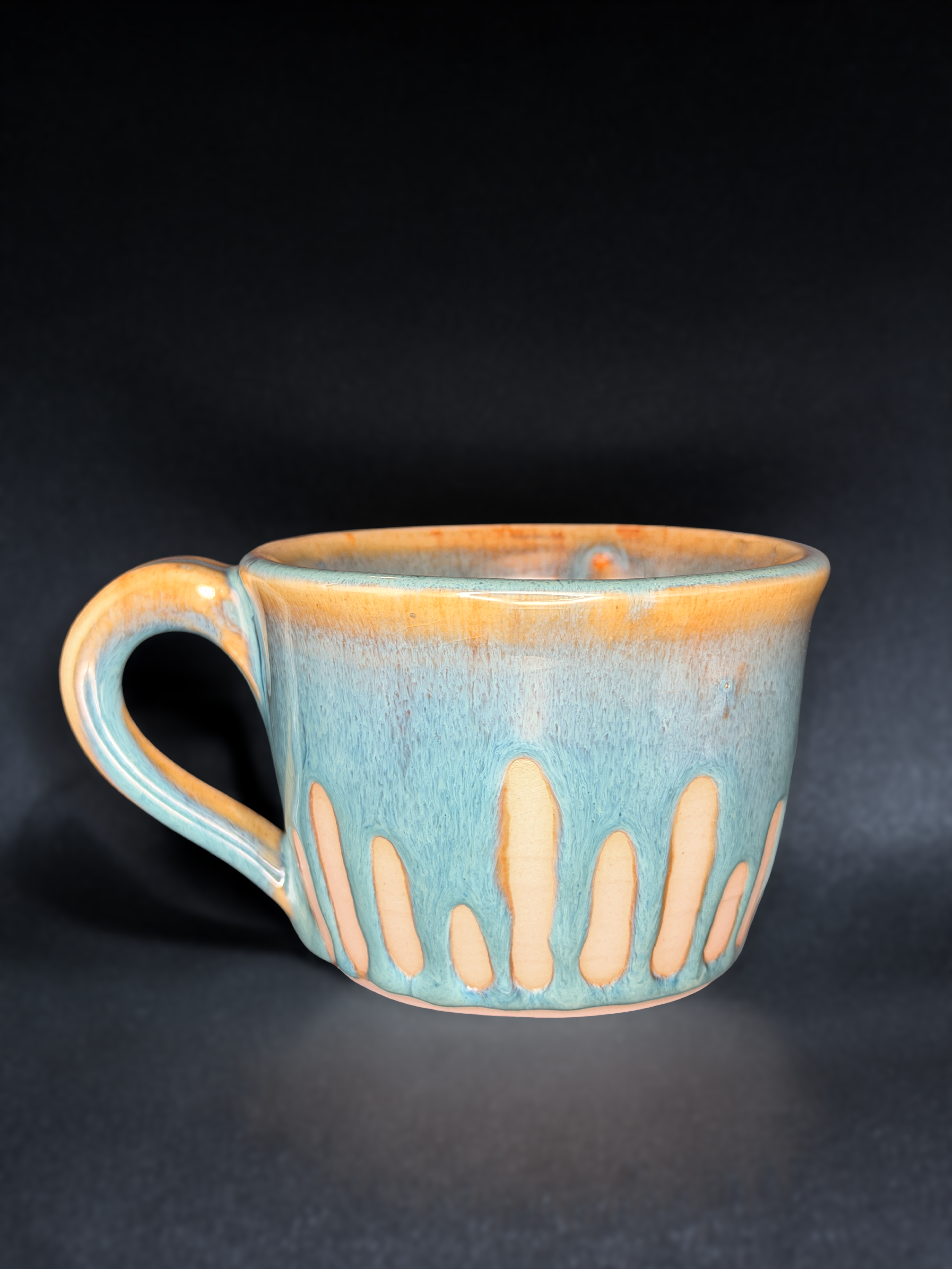 Blue handled ceramic cup by Mira Etingof with detailed surface decoration