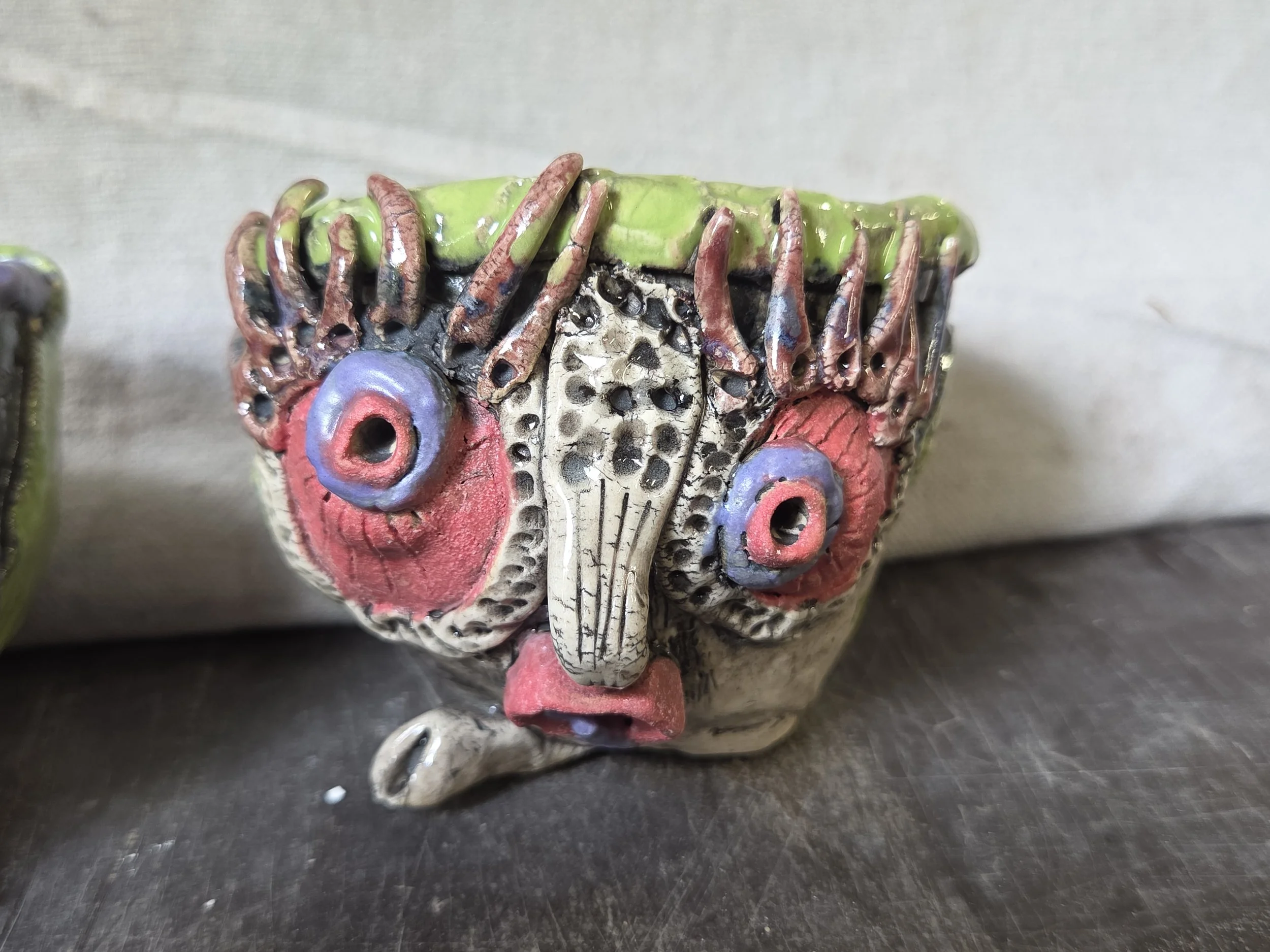 Glazed sculptural face vessel by Moe Lewis-Wolf with layered and carved surface details