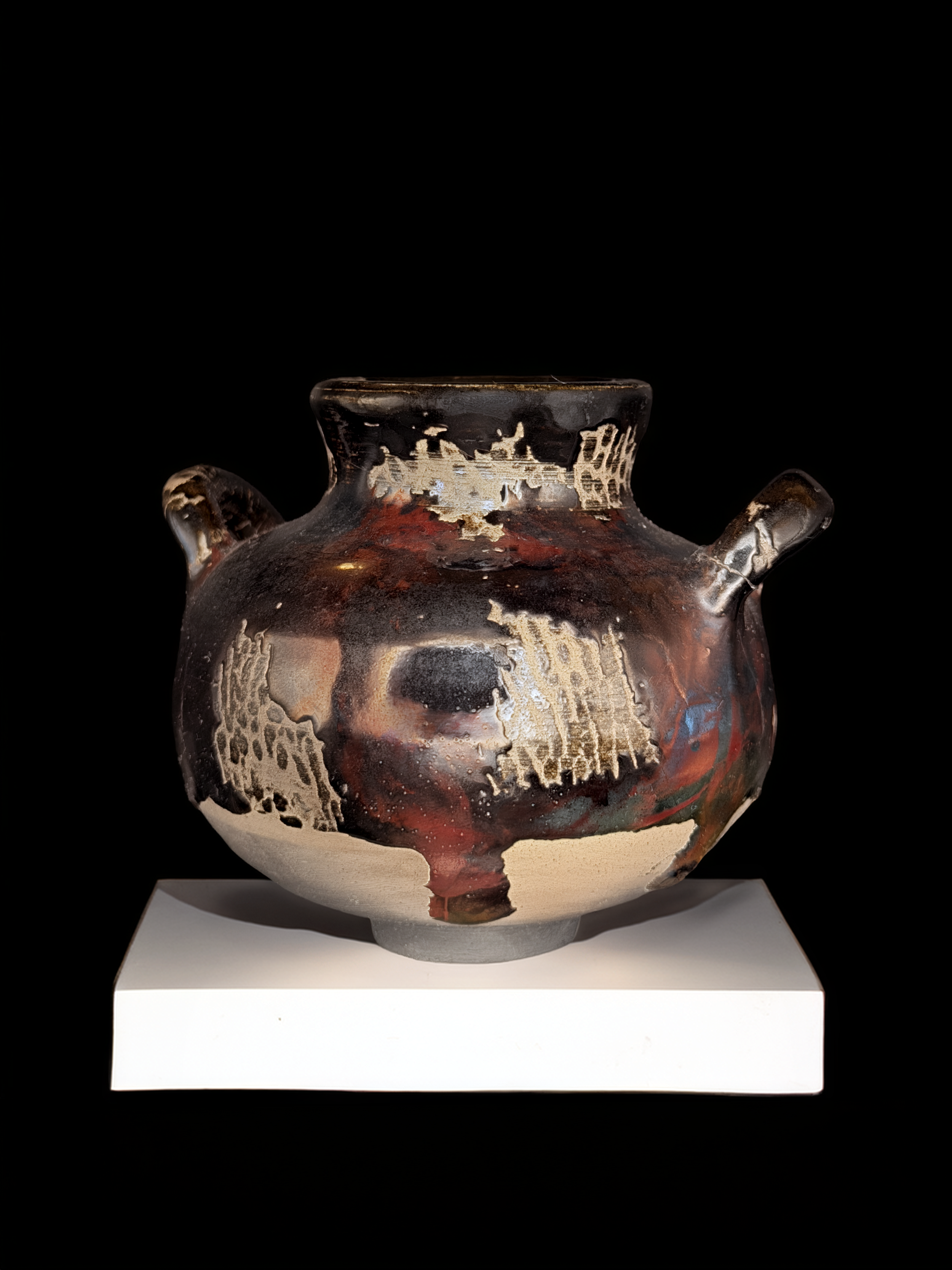 Dark glazed amphora by Mira Etingof with carved and painted surface imagery