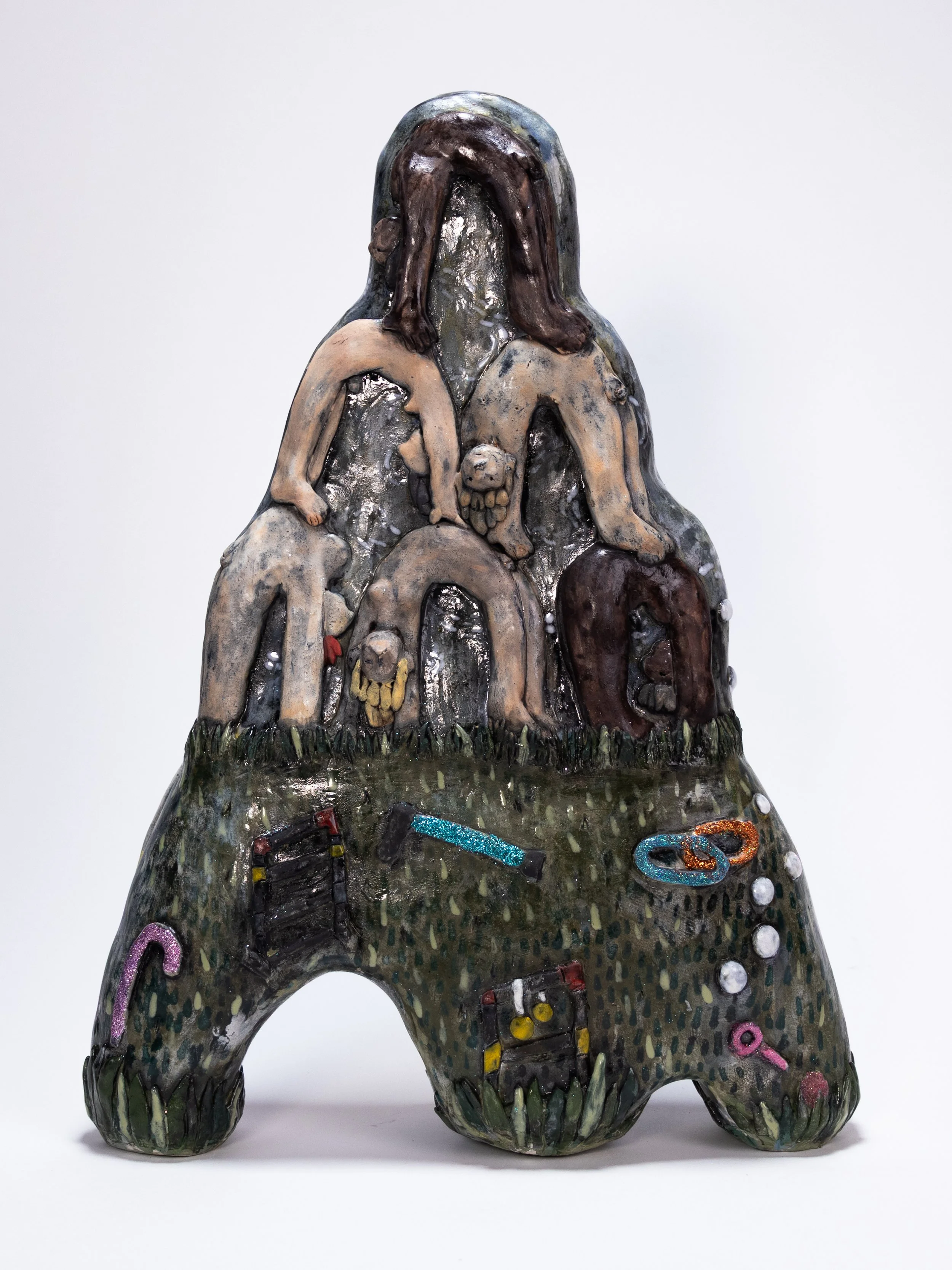 Figurative ceramic sculpture with nested bodies above a dark landscape