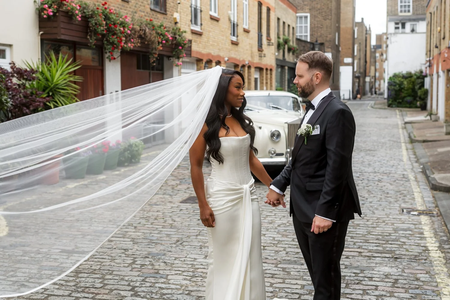 Louise and Clayton in a cobbled London mews on their wedding day