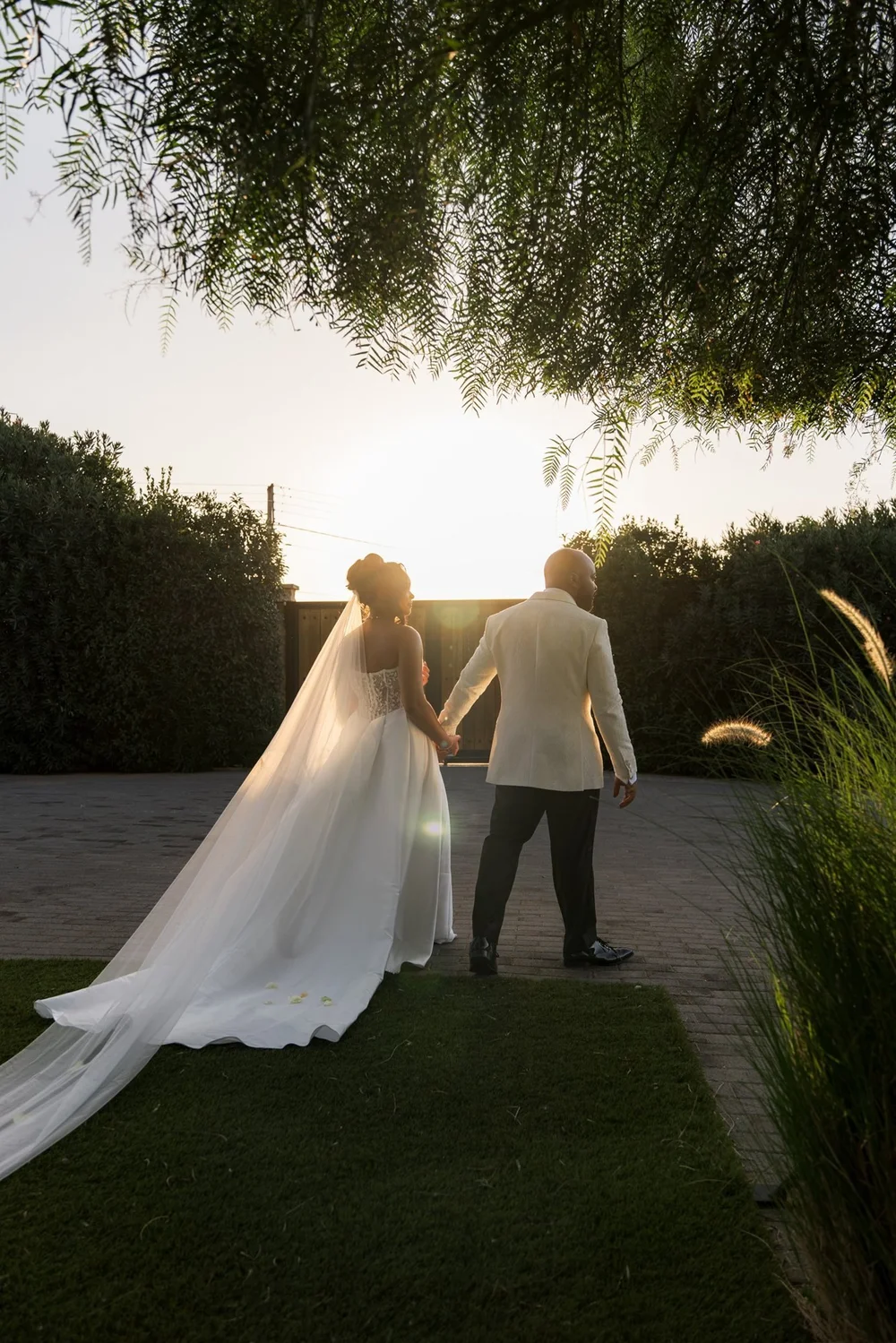 Couple walking hand in hand at golden hour, from a cinematic wedding film