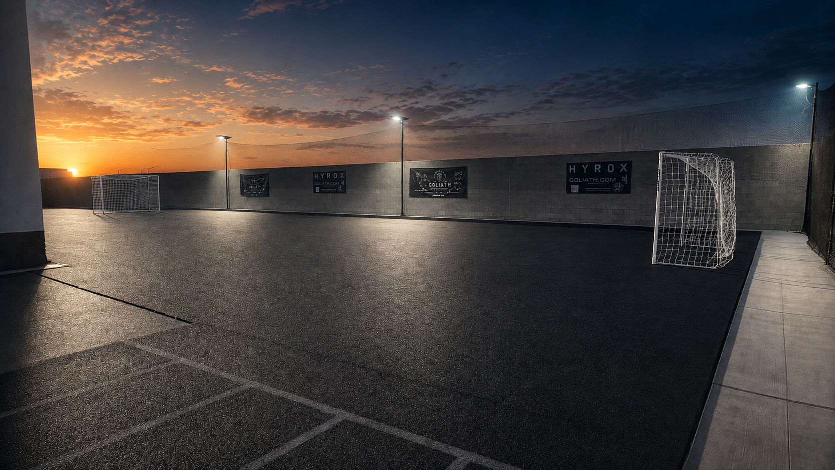 Wide view of the Goliath soccer complex, goals and field lighting at sunset