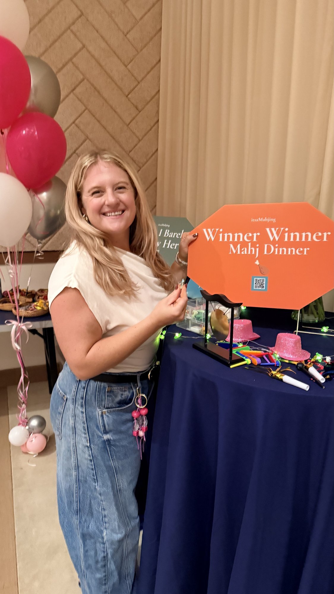 Prize station with a gong and Winner Winner Mahj Dinner sign at an itsaMahjing event