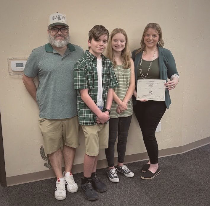 Ben and Dera Curliss with their two kids at Aligned Cowork Lounge