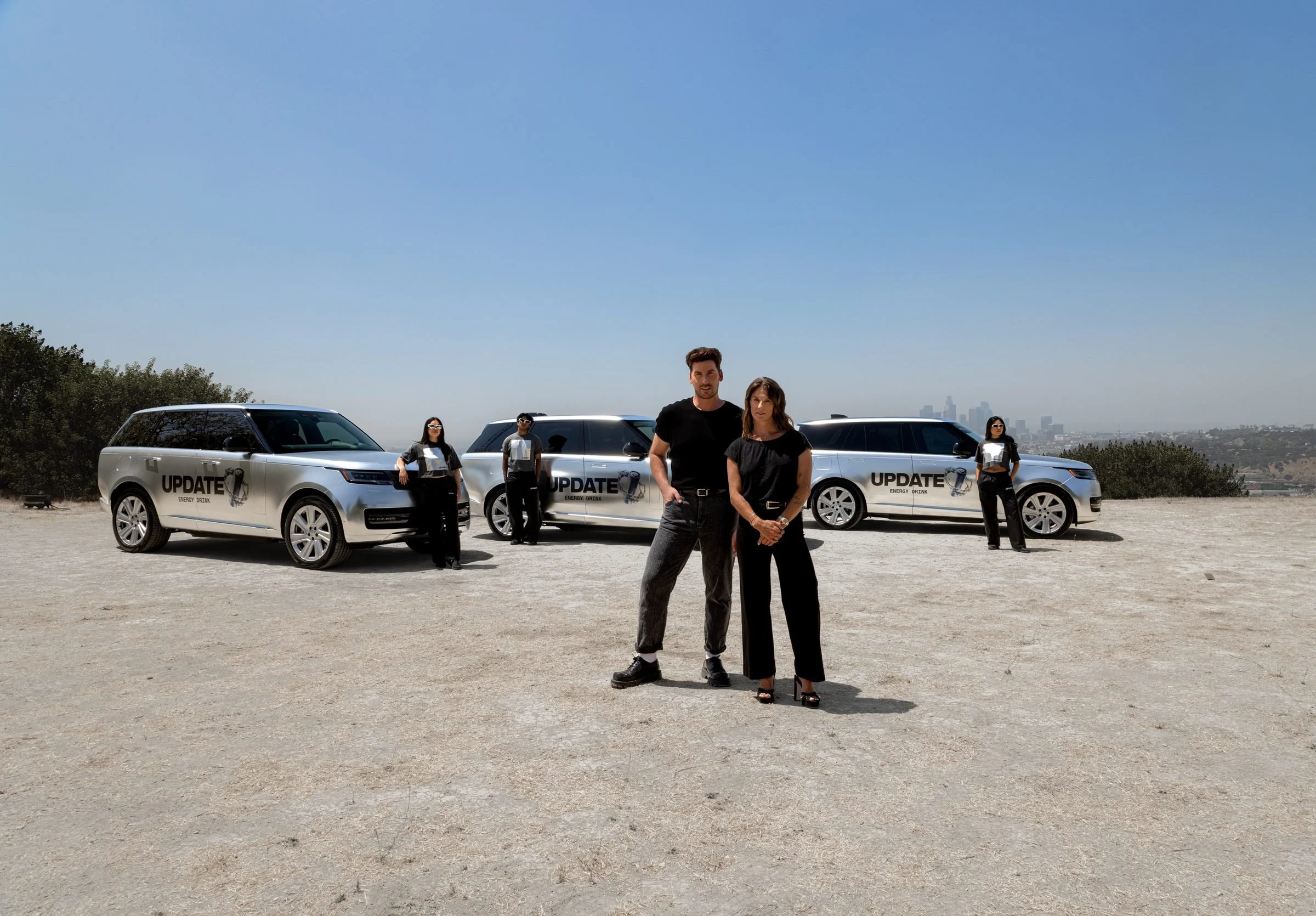Front & Center team and ambassadors in front of three UPDATE-wrapped Range Rovers