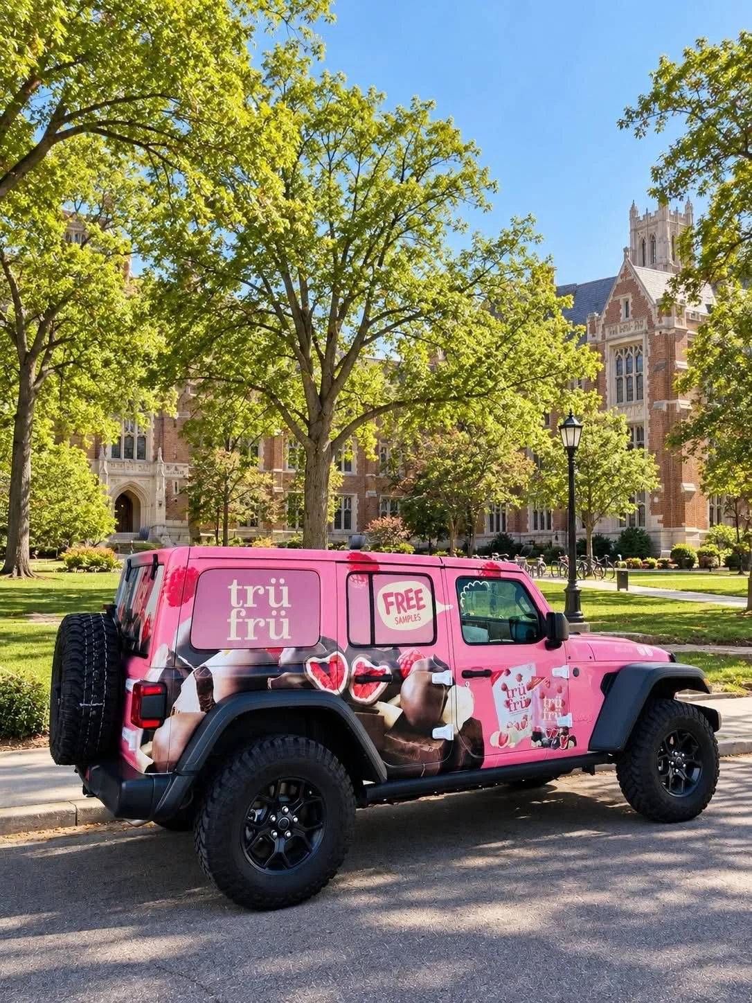 Pink Tru Fru-wrapped Jeep Wrangler at a campus stop during a branded vehicle sampling program