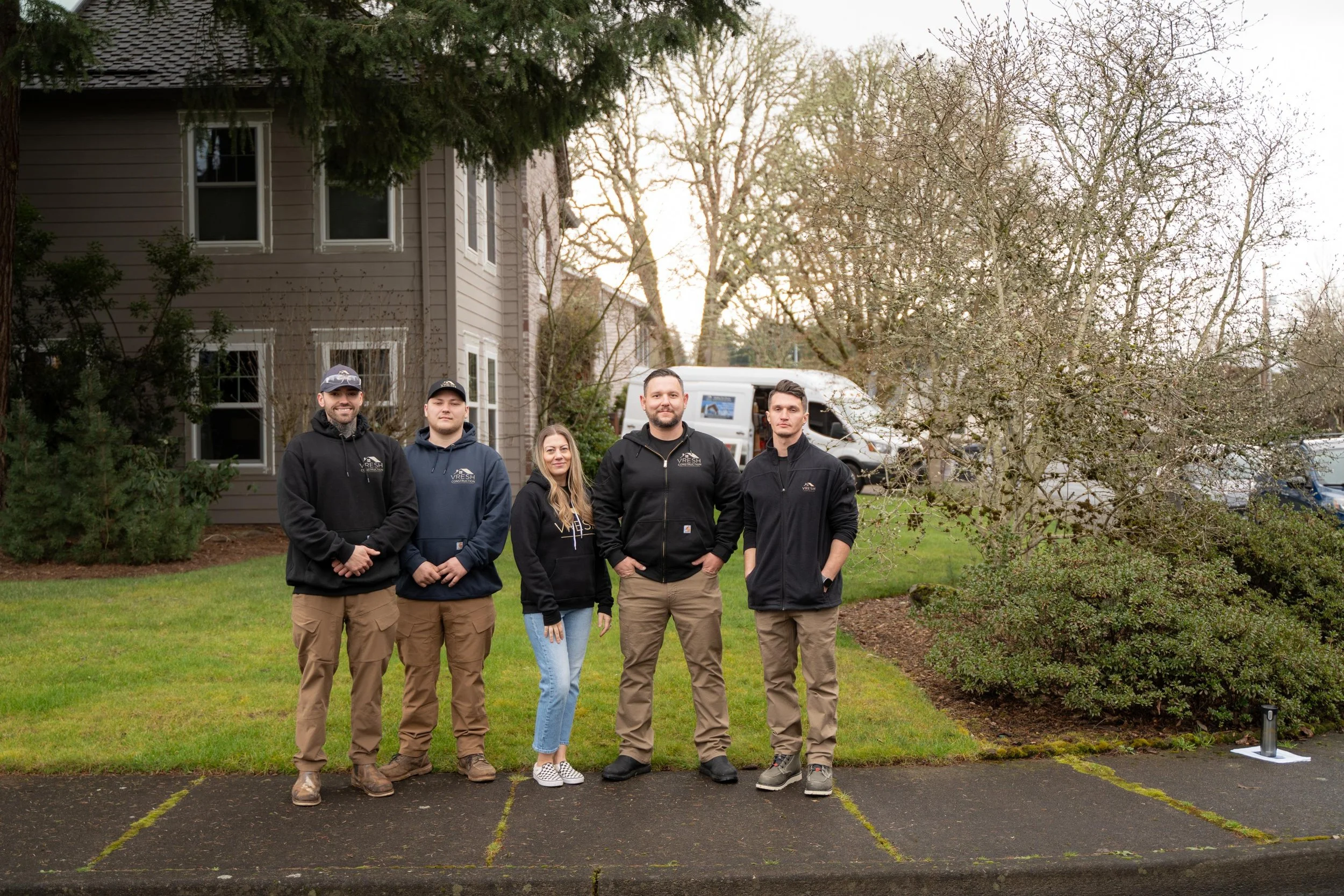 VResh Construction crew standing together on the lawn in front of a home